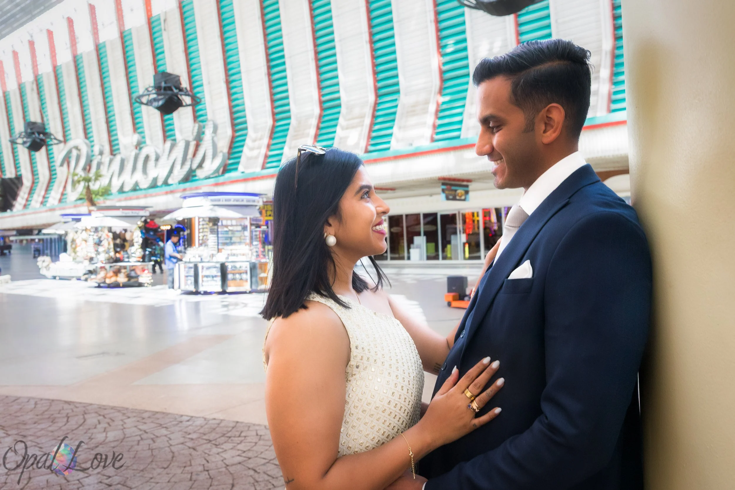 Bride and groom smiling under the Binion’s sign during their downtown Las Vegas elopement.
