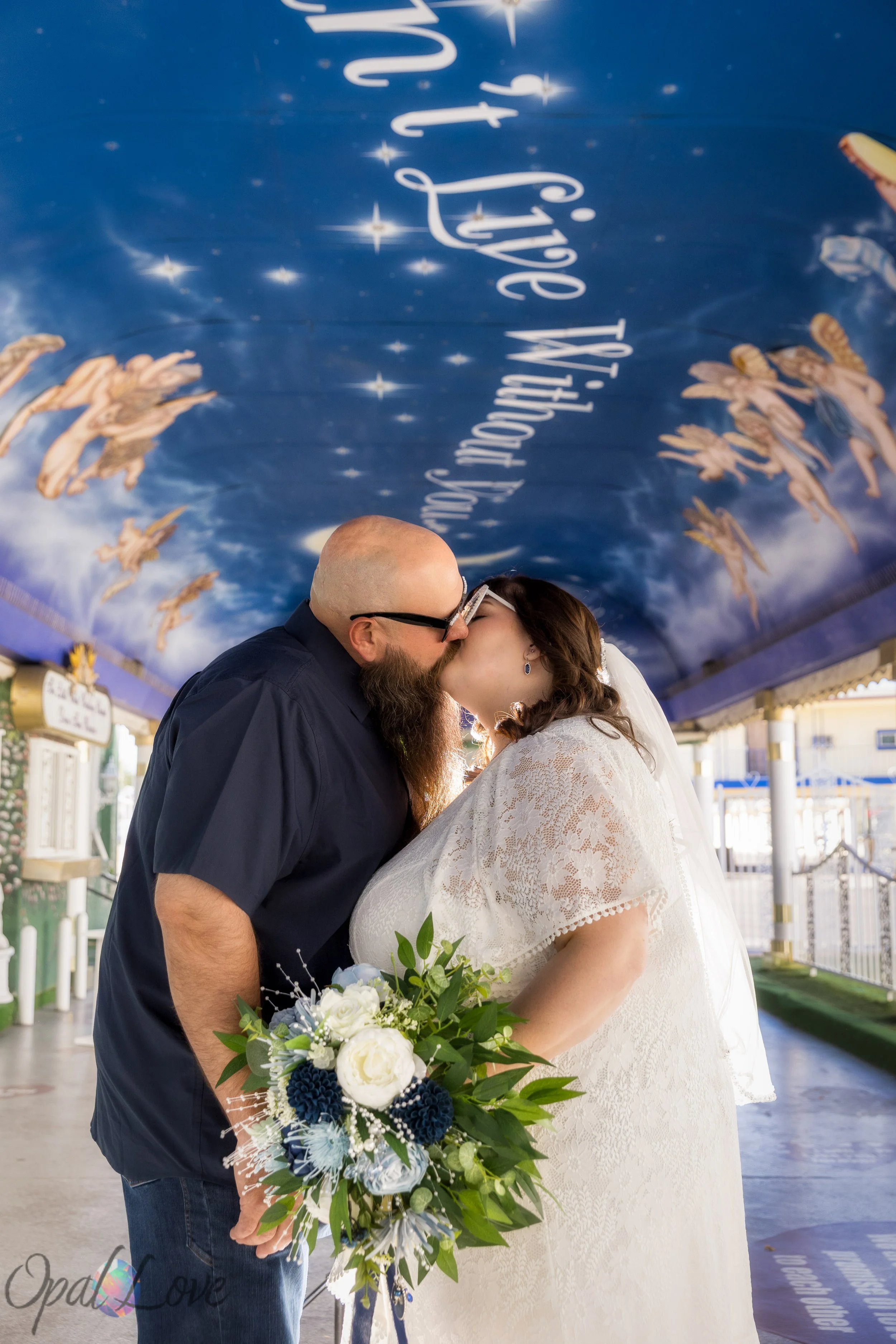 Couple kissing beneath the star painted ceiling inside the Tunnel of Love.