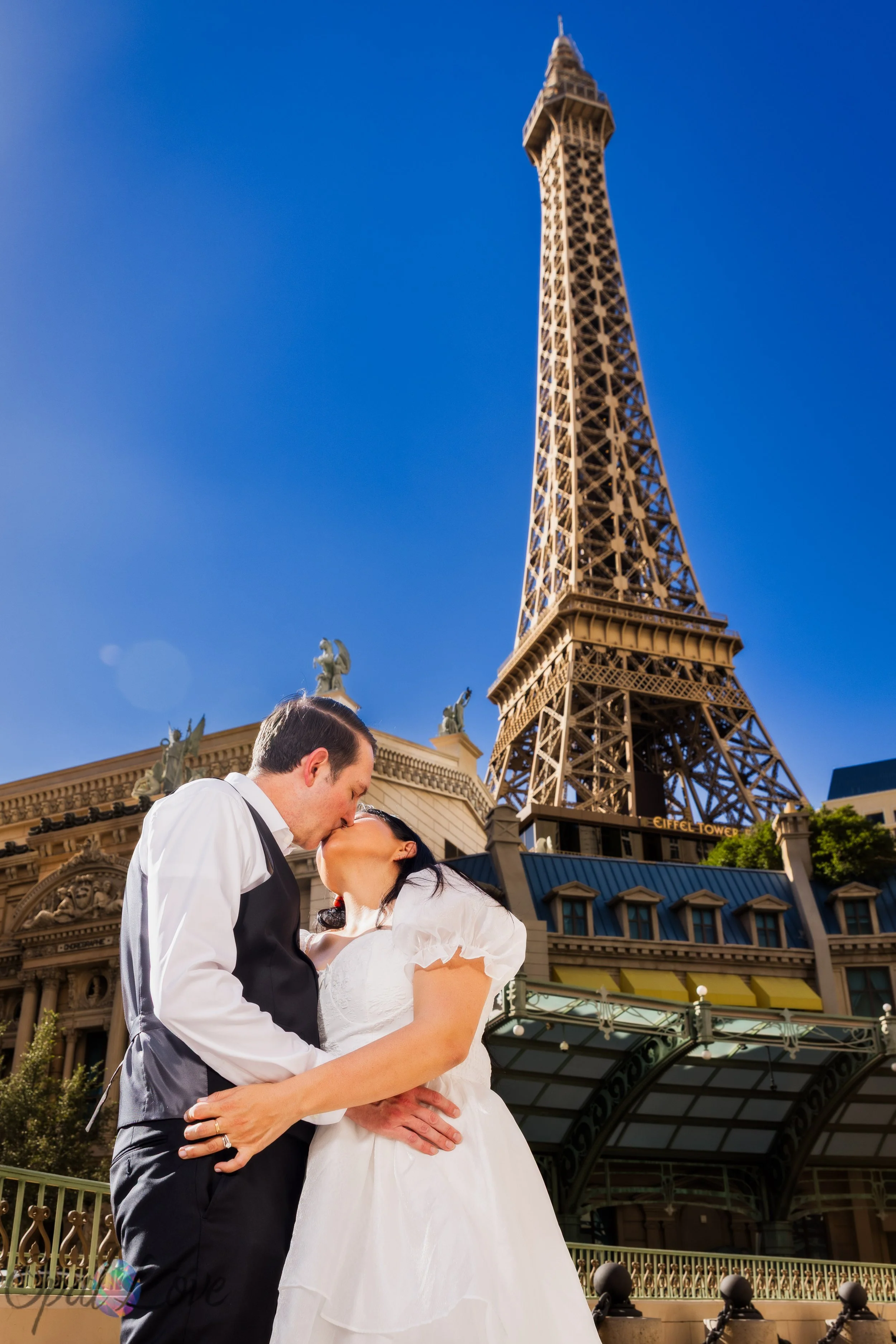Wedding couple kissing with the Eiffel Tower at Paris Las Vegas in the background
