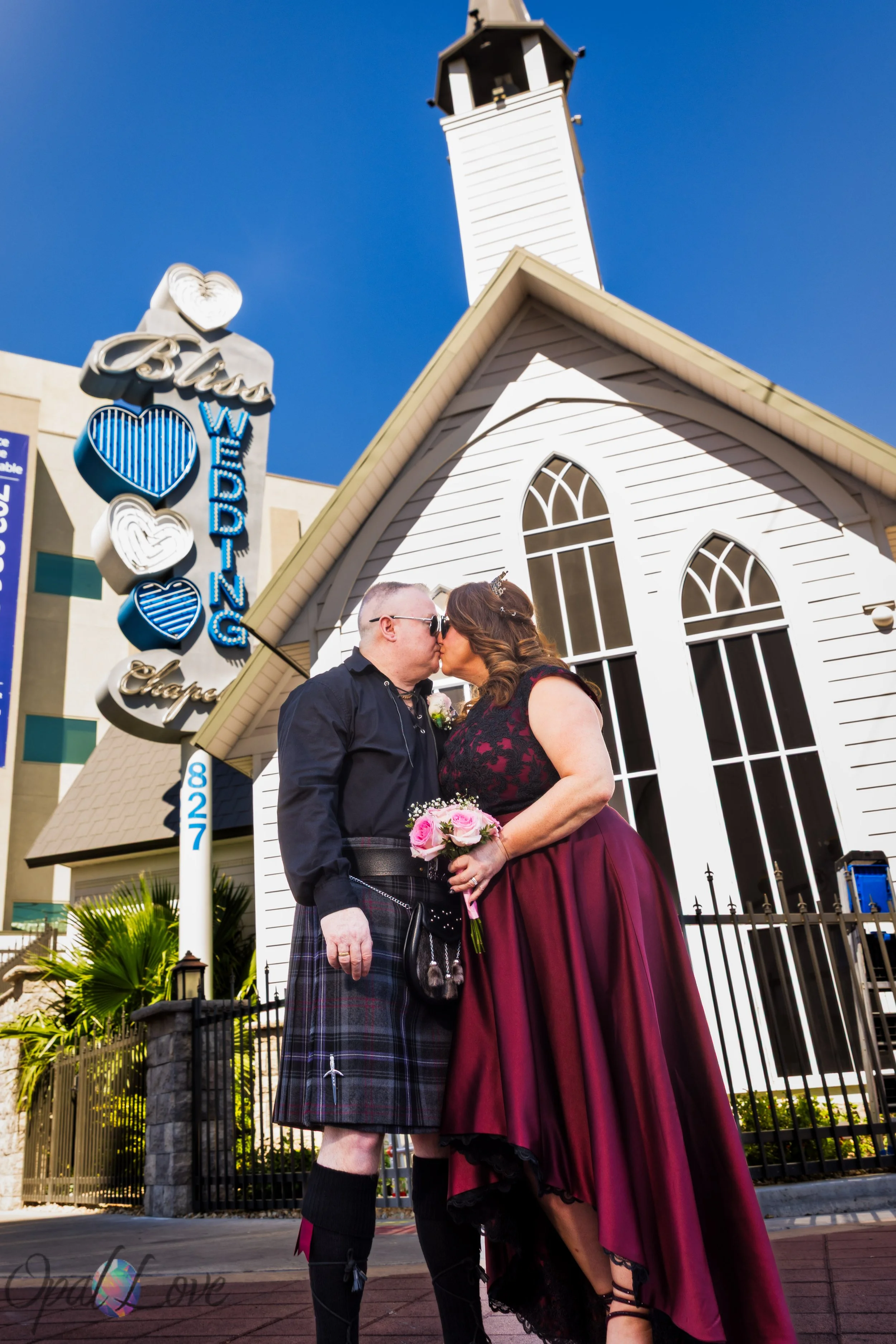 Newly married couple kissing outside Bliss Wedding Chapel in Las Vegas after their wedding ceremony.