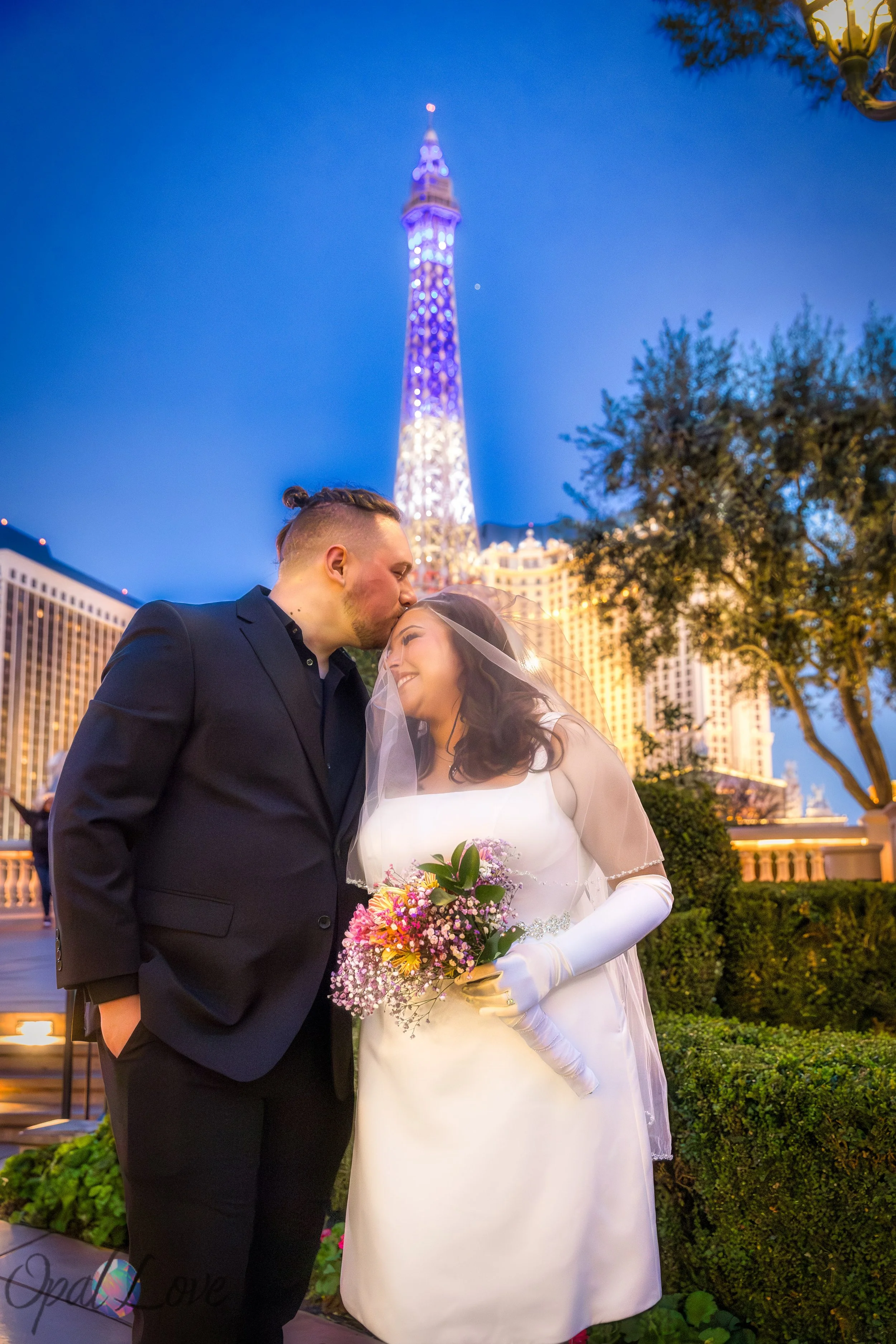 Bride holding a bouquet while standing near the Bellagio fountains during a Las Vegas anniversary photo session.