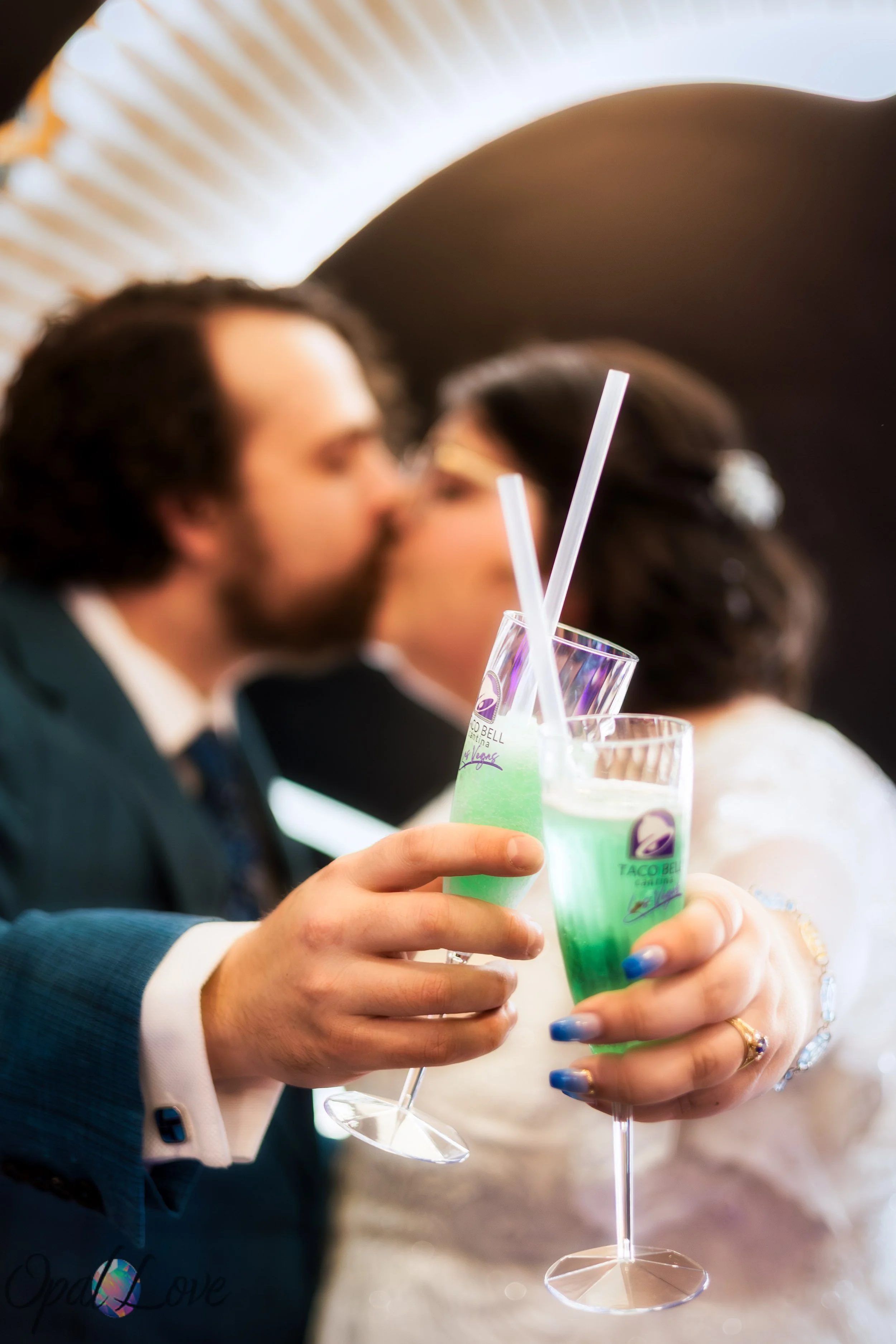 Couple kissing while toasting with frozen Baja Blast drinks.