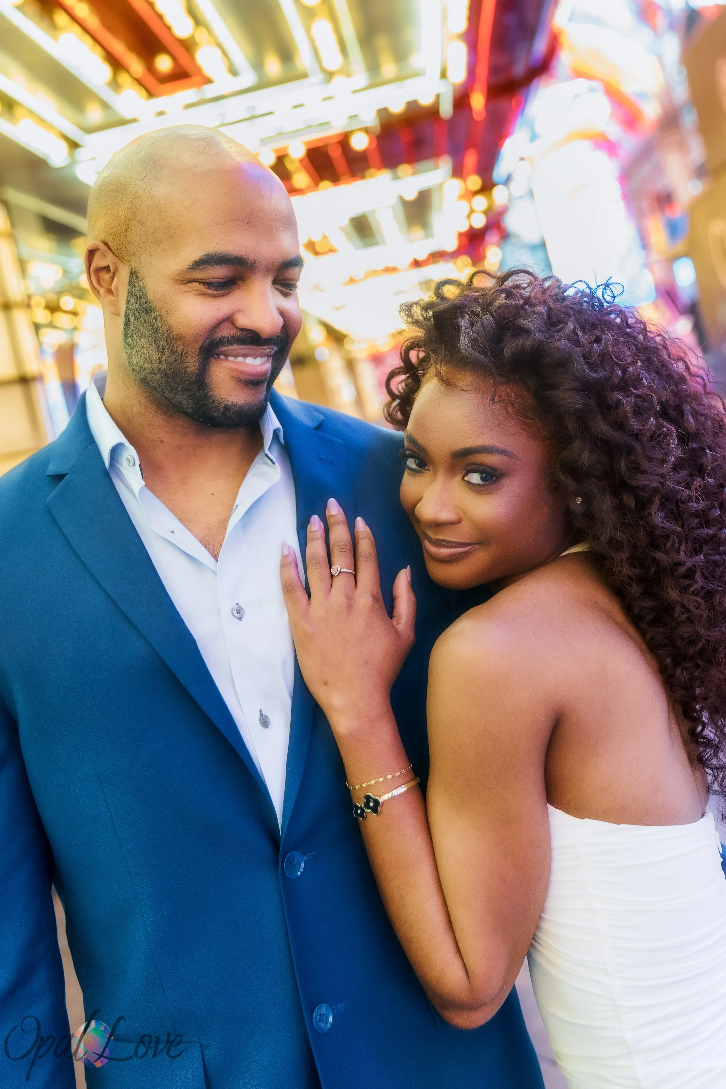 Close portrait of couple surrounded by neon lights on Fremont Street in Las Vegas.