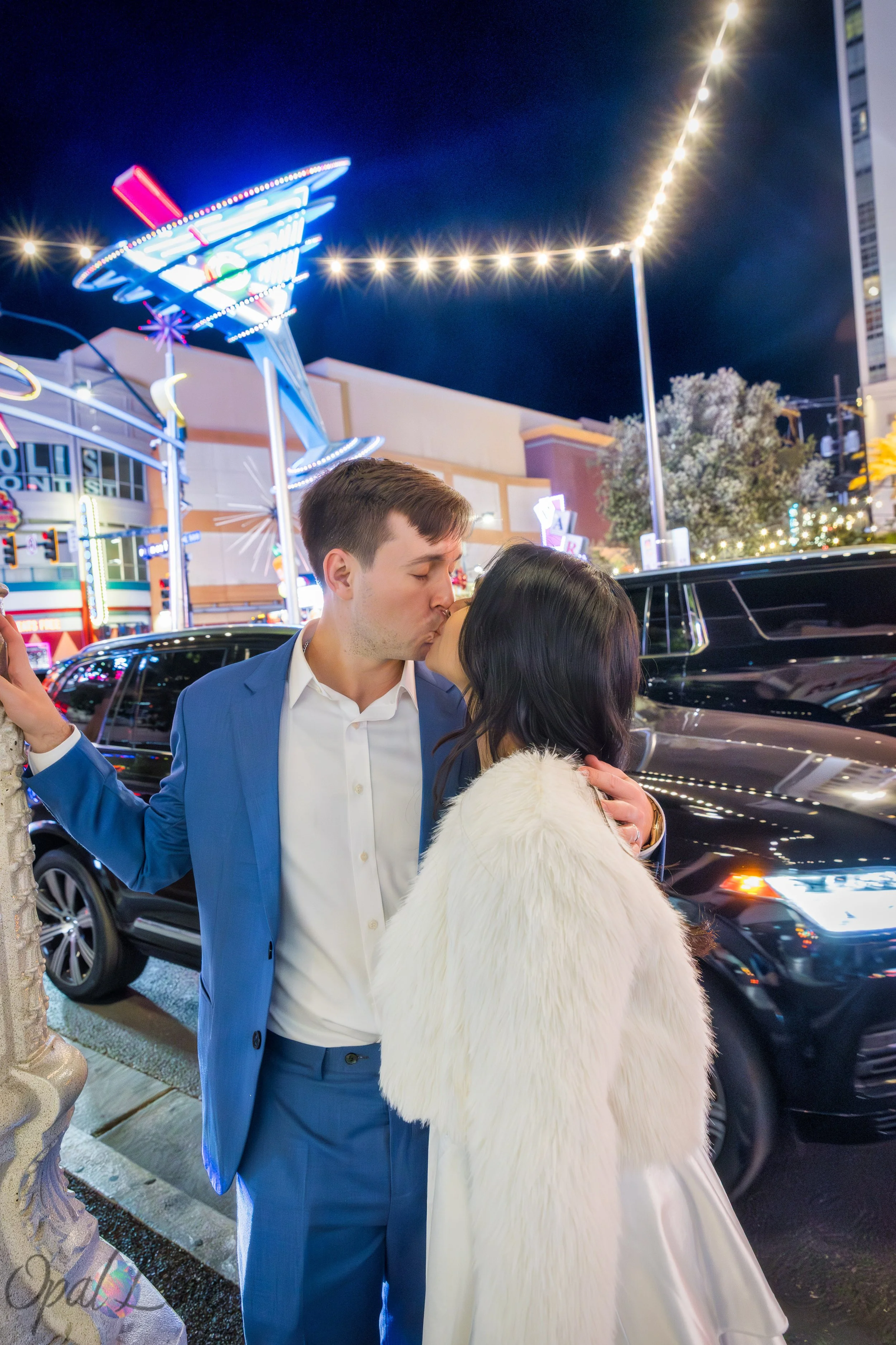 Couple kissing under neon lights on Fremont Street in Downtown Las Vegas at night