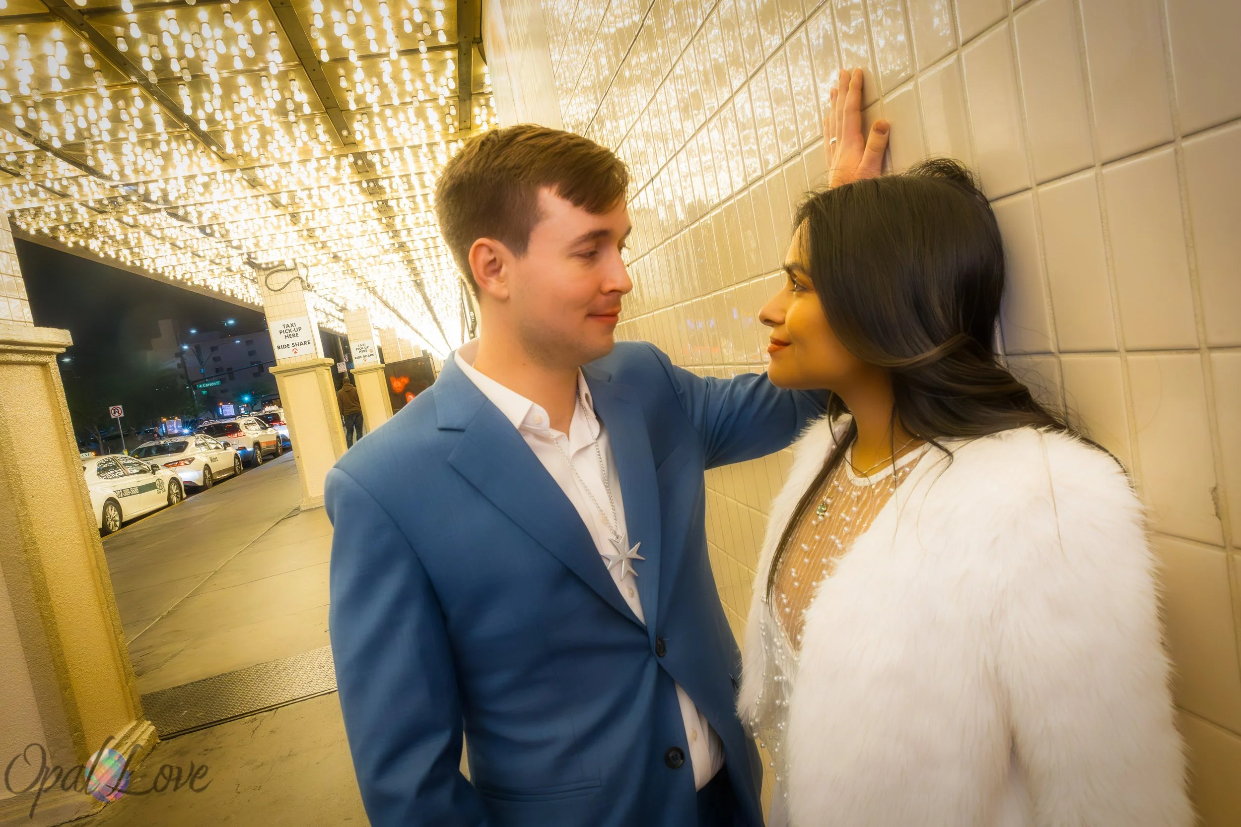 Couple sharing quiet moment under warm lights on Fremont Street in Las Vegas