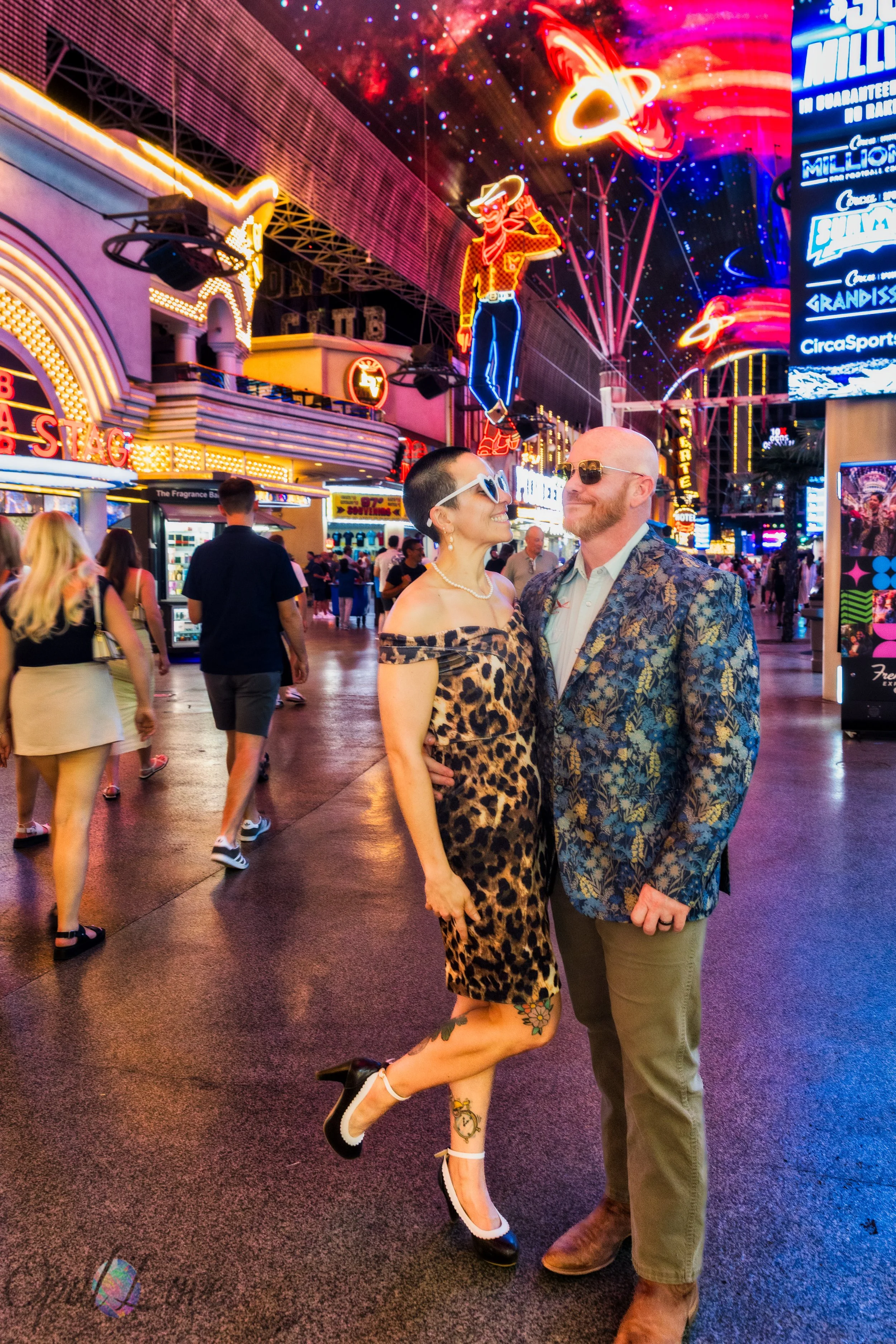 Maddie and Ashley posing together beneath the neon lights of the Fremont Street Experience in Downtown Las Vegas.