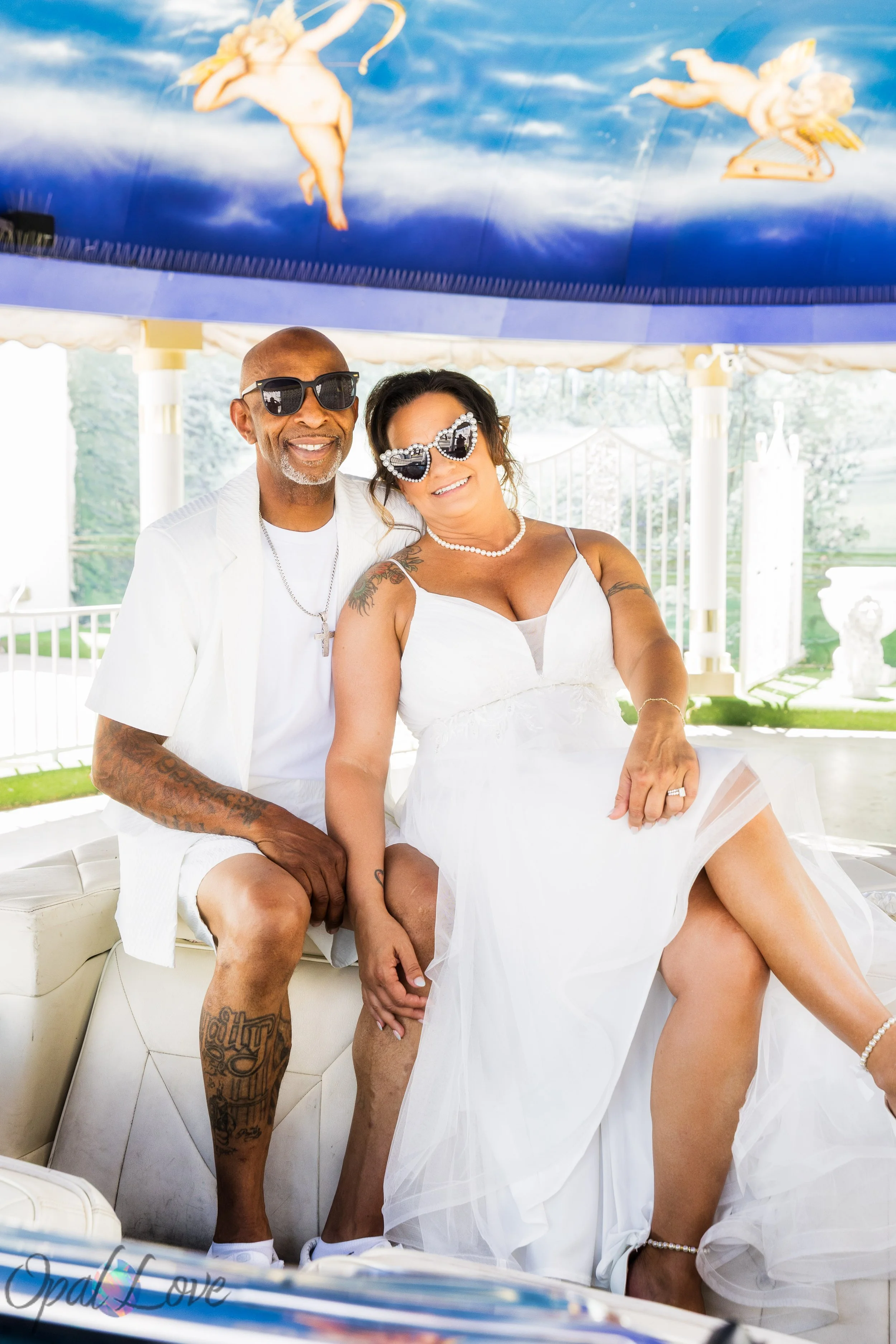 Stephanie and Jacent wearing statement sunglasses for a fun newlywed portrait at Little White Wedding Chapel in Las Vegas.