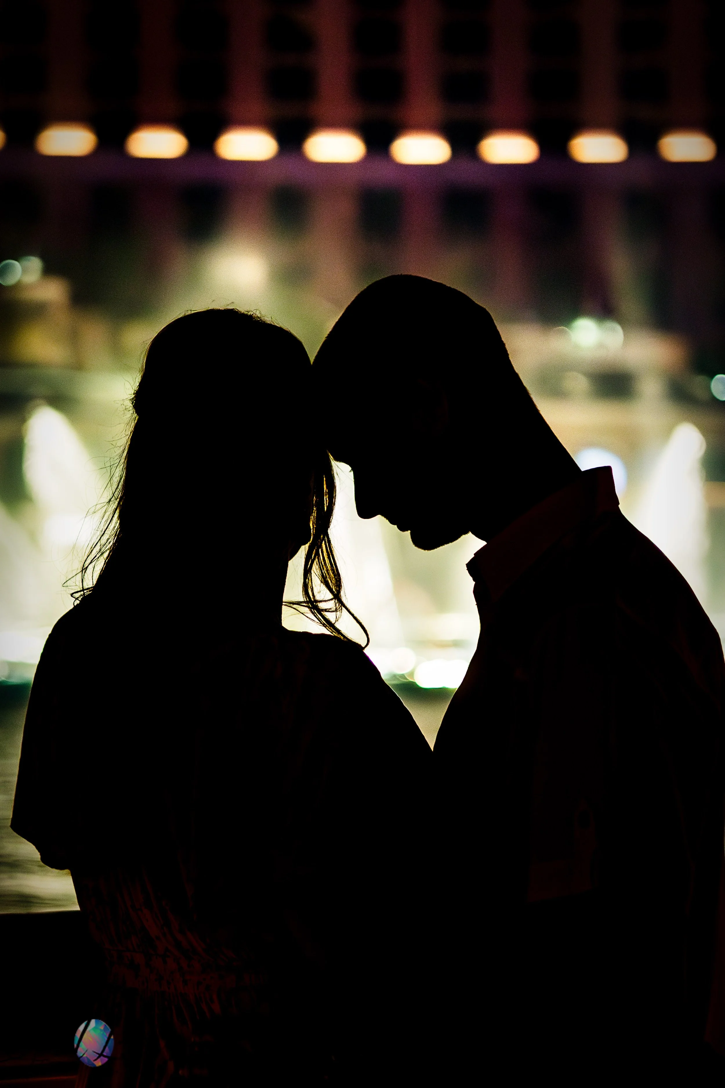 Silhouette portrait of anniversary couple in front of the Bellagio fountains at night in Las Vegas.
