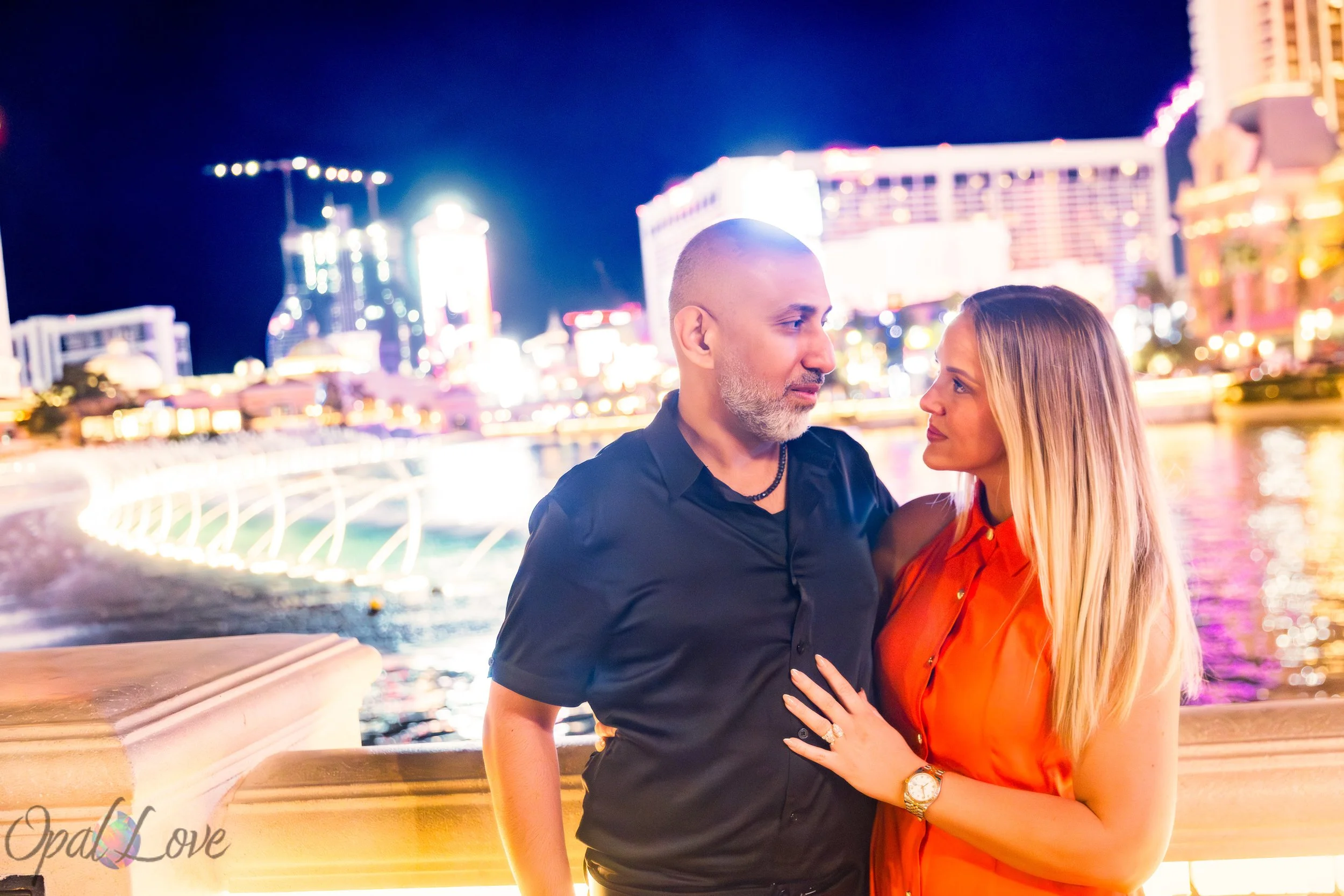 Couple portrait overlooking the Bellagio Fountains at night in Las Vegas