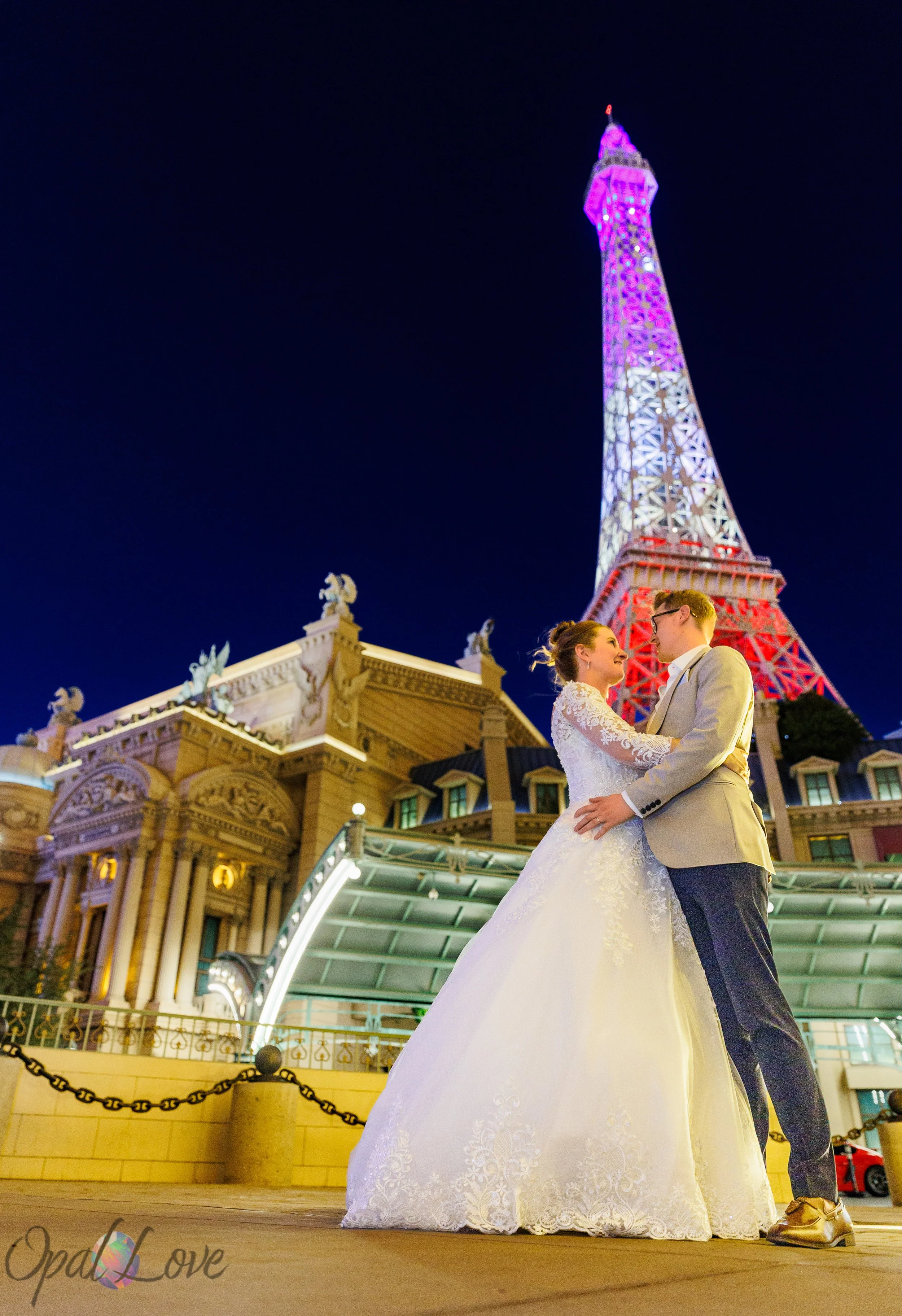 Paris Las Vegas wedding portraits under the glowing Eiffel Tower captured by Opal Love Photography.