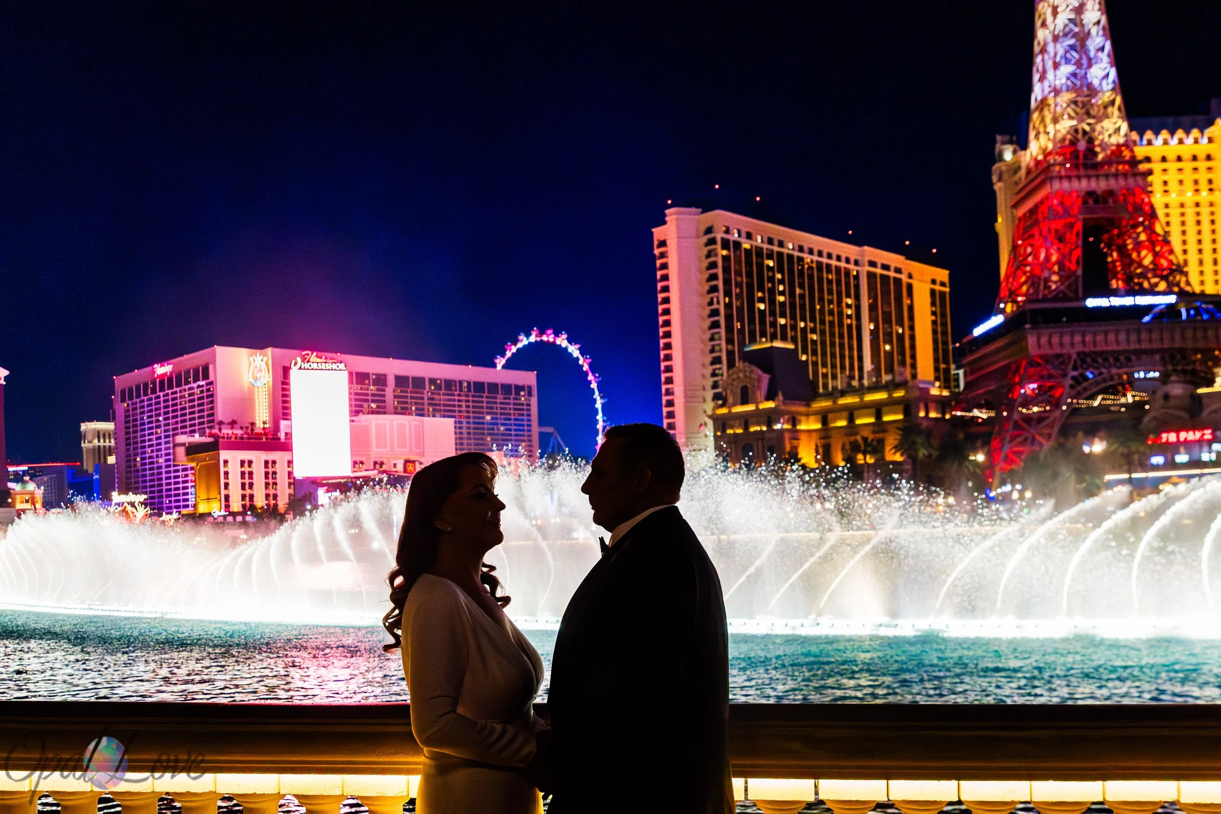 Silhouette of couple in front of Bellagio fountains during nighttime water show