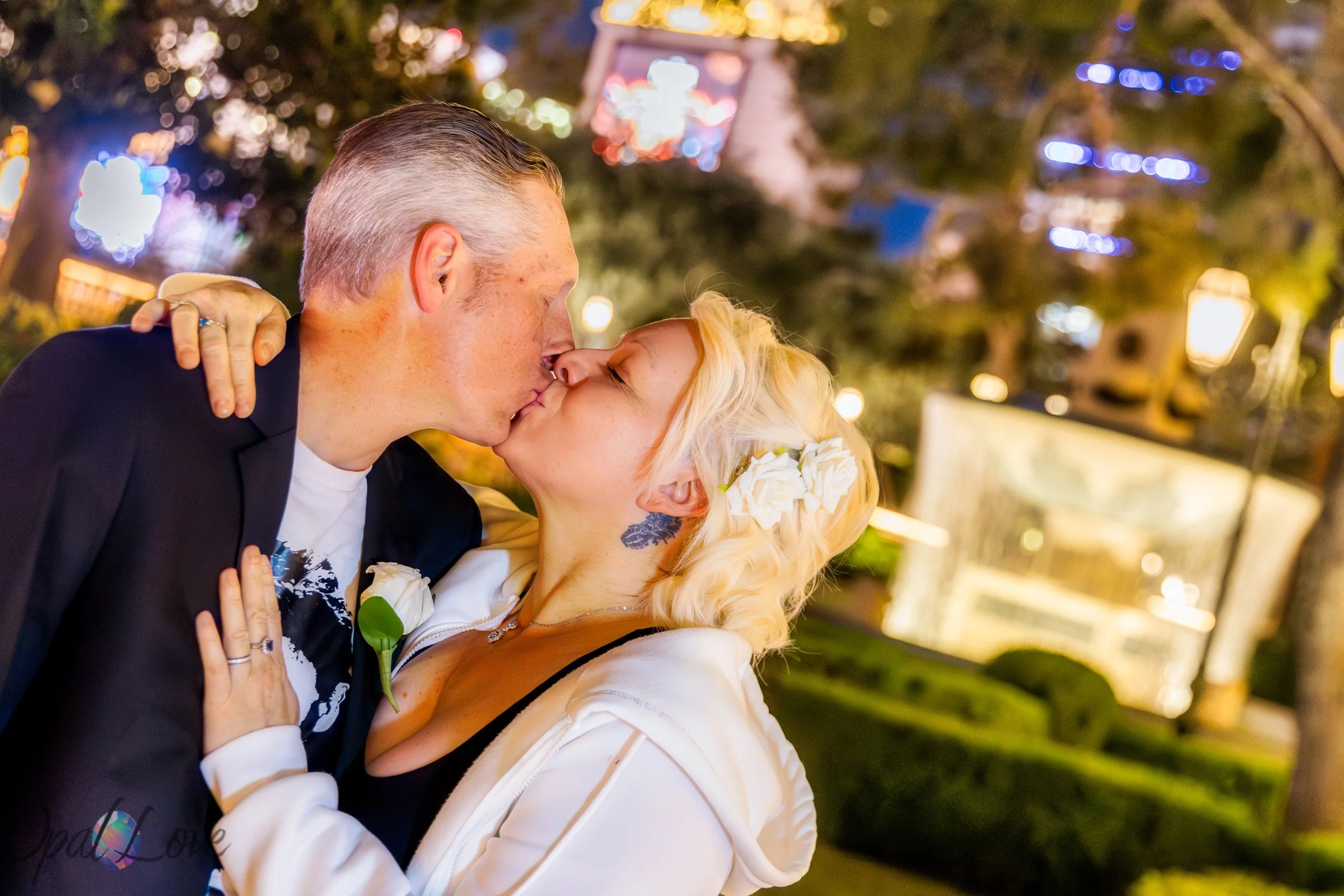 Close up romantic kiss with Bellagio area lights glowing in the background