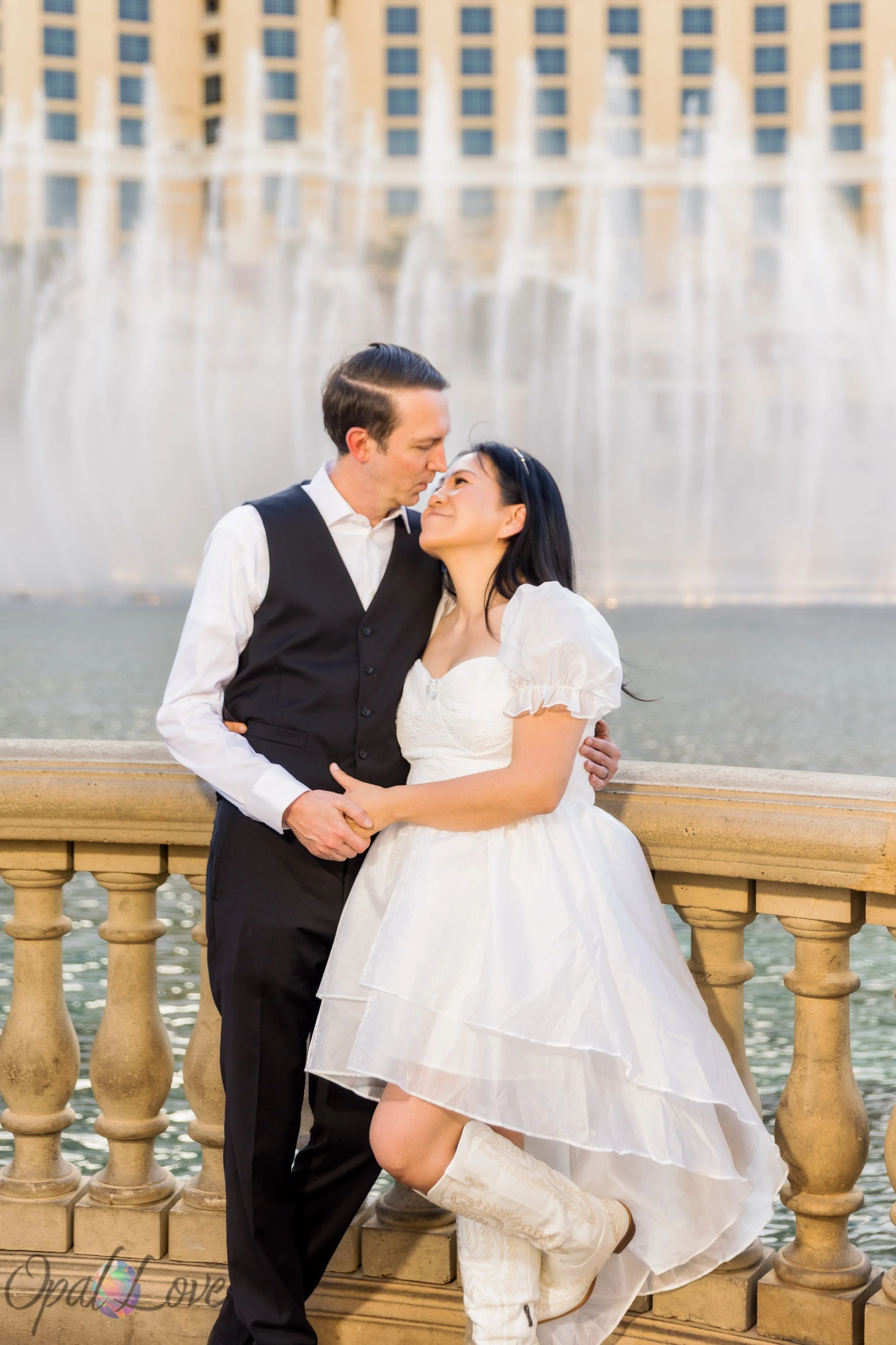 Bride and groom sharing a moment in front of the Bellagio Fountains during Las Vegas wedding portraits