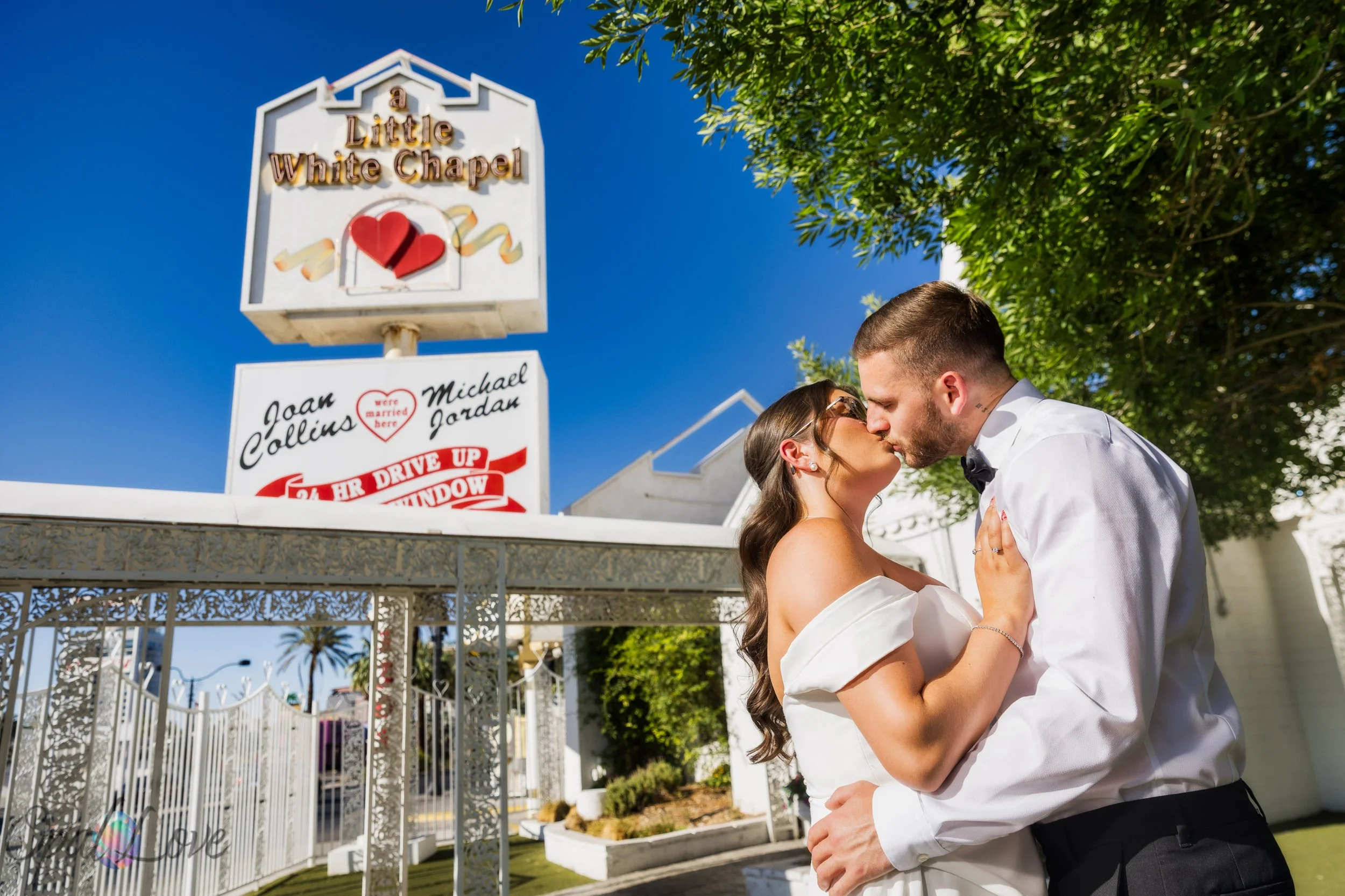 Newly married couple kissing outside Little White Wedding Chapel in Las Vegas.