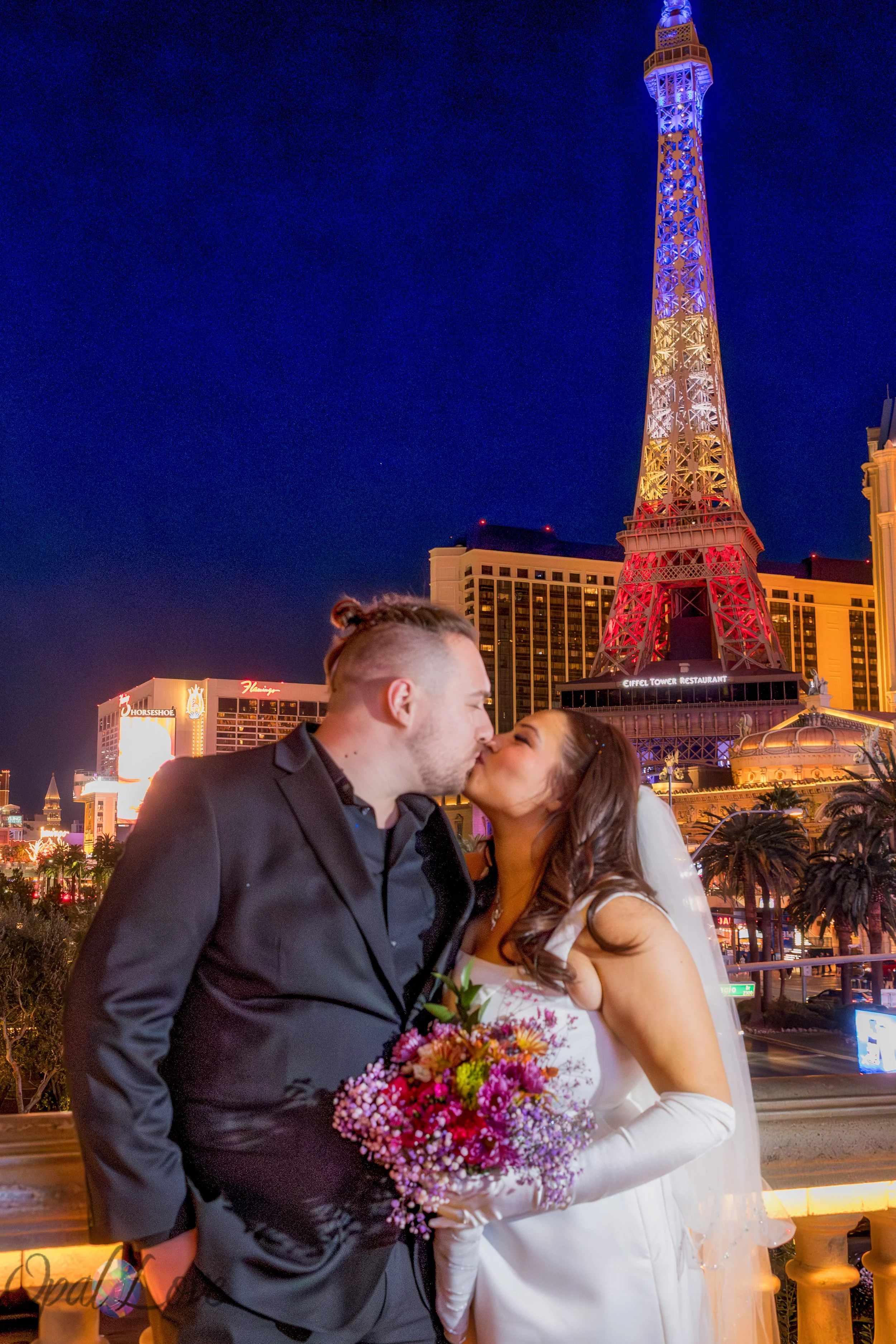 Anniversary couple walking together near the Bellagio fountains at night in Las Vegas.