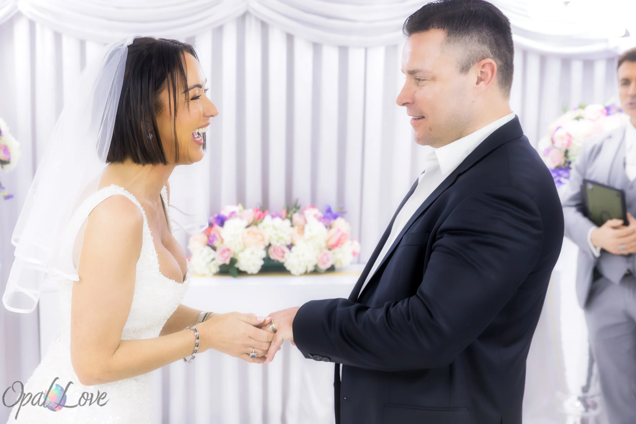 Bride and groom exchanging rings during an intimate ceremony at Little White Wedding Chapel in Las Vegas.