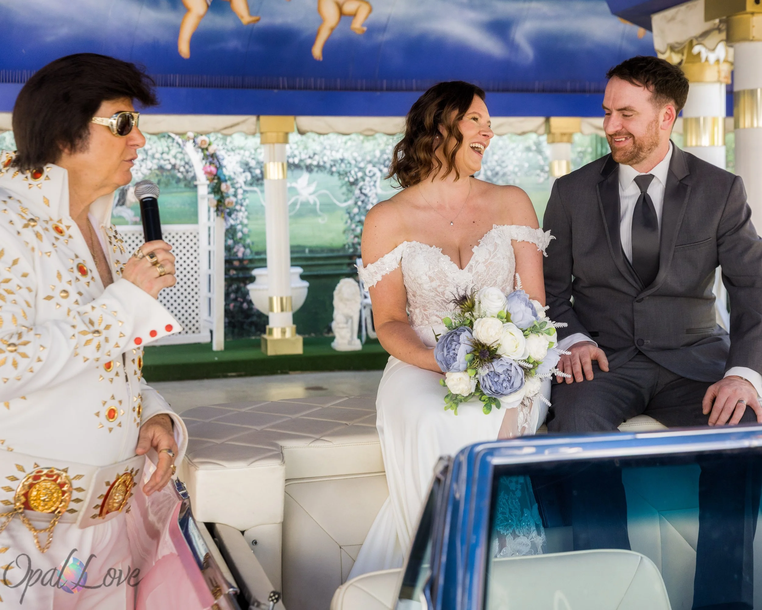 Couple seated in a pink Cadillac during a ceremony with an Elvis impersonator.