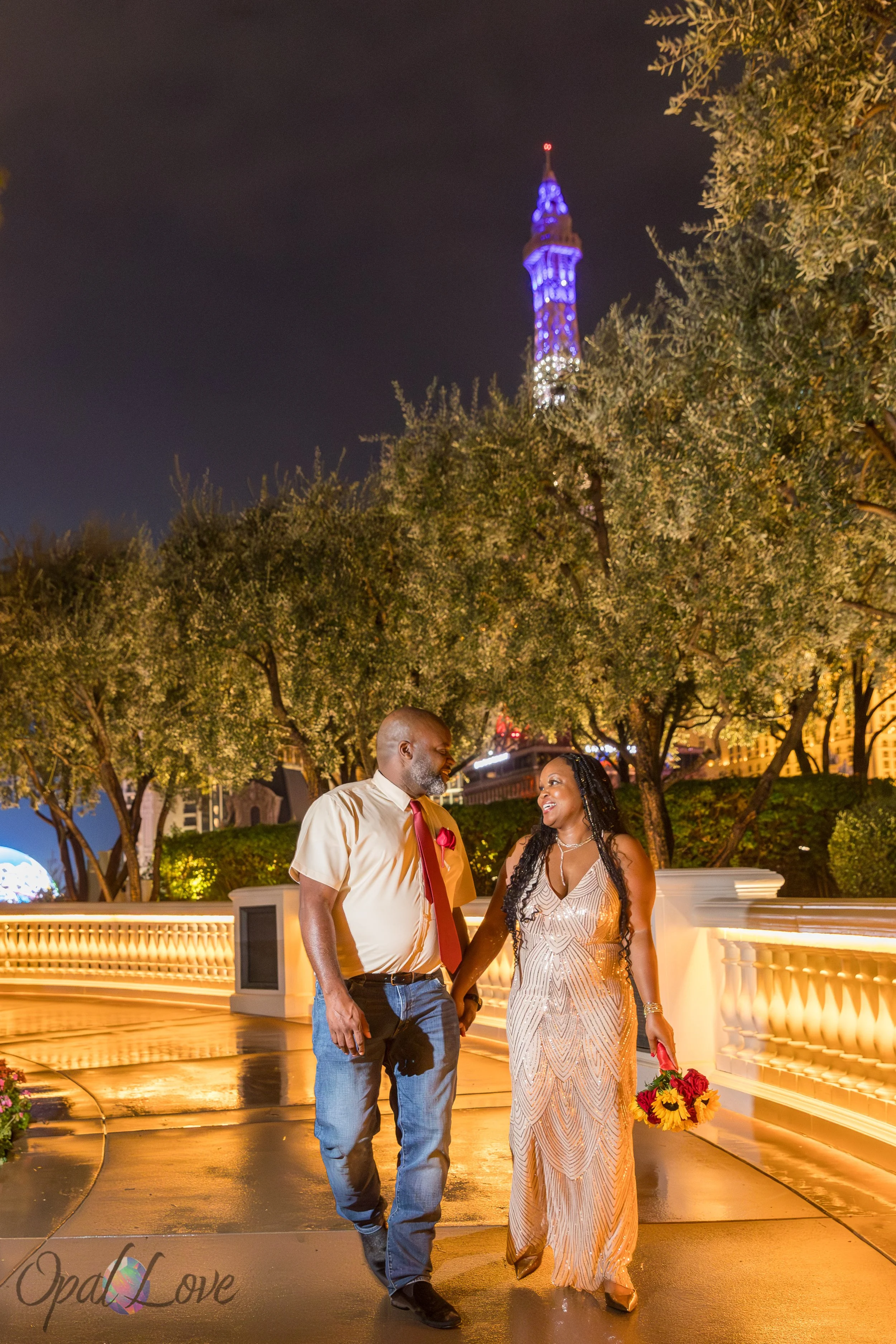 Couple walking hand in hand along Bellagio promenade at night