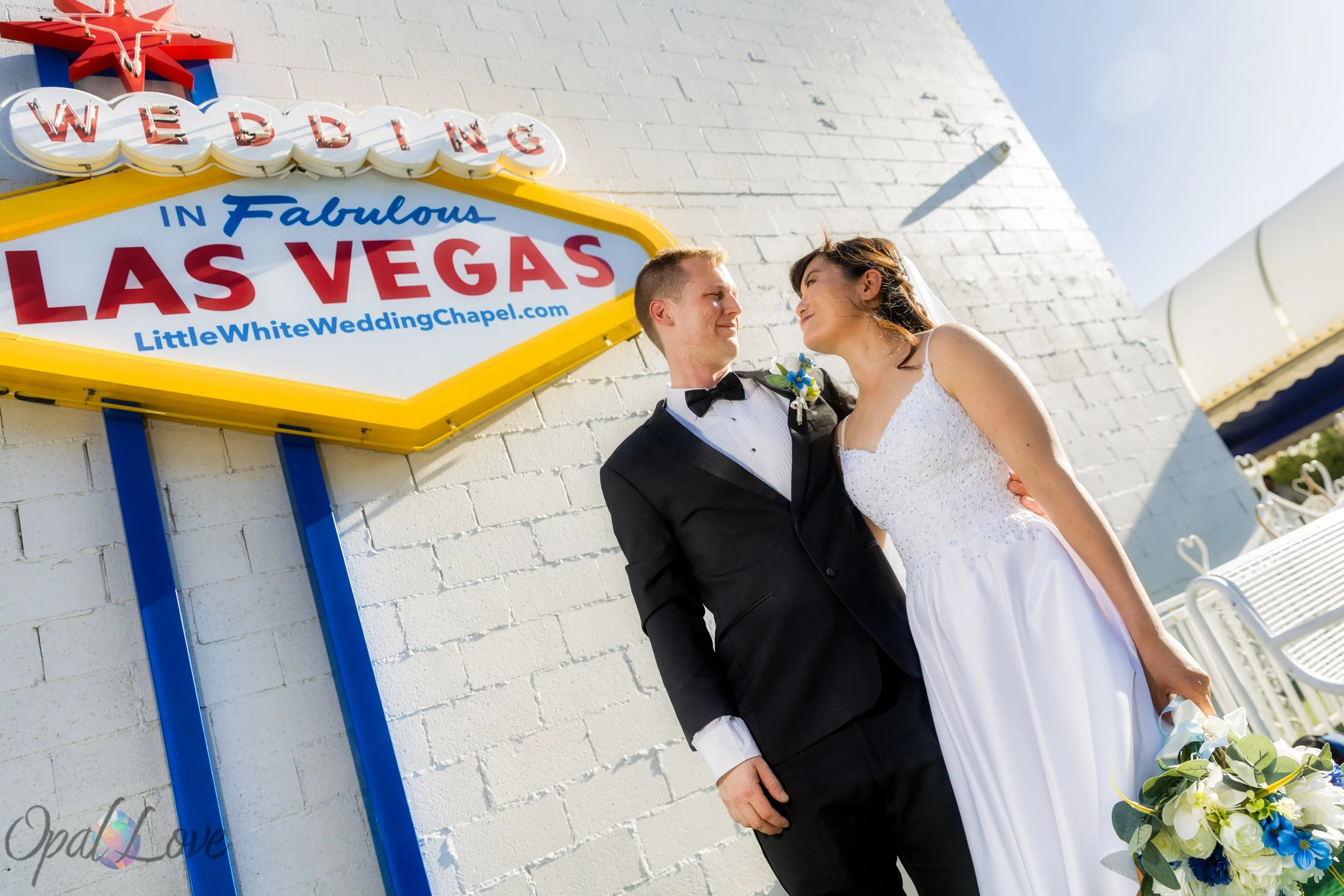 Bride and groom standing outside the Little White Wedding Chapel during their Las Vegas wedding.