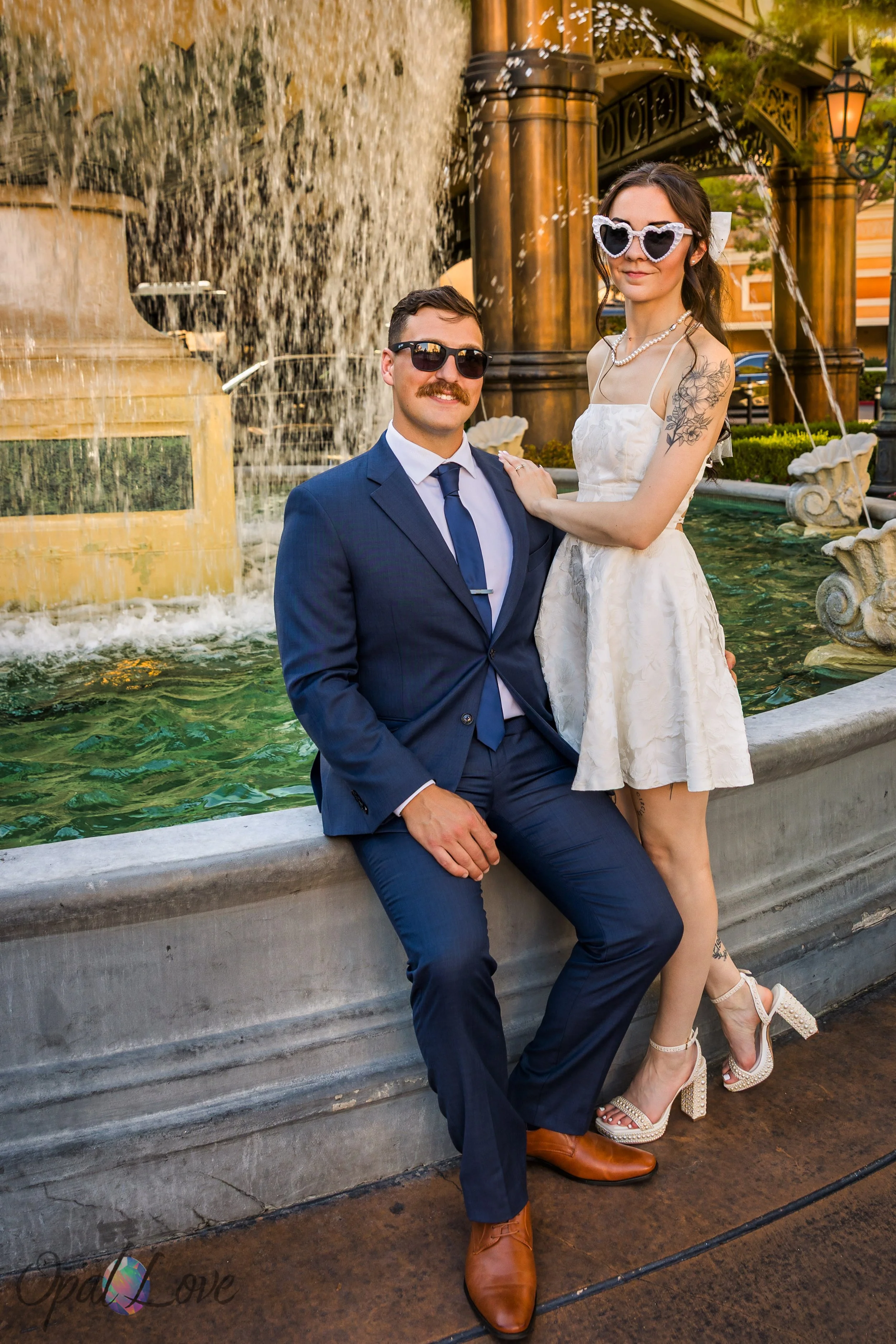 Couple posing by Bellagio fountain during their Las Vegas elopement.