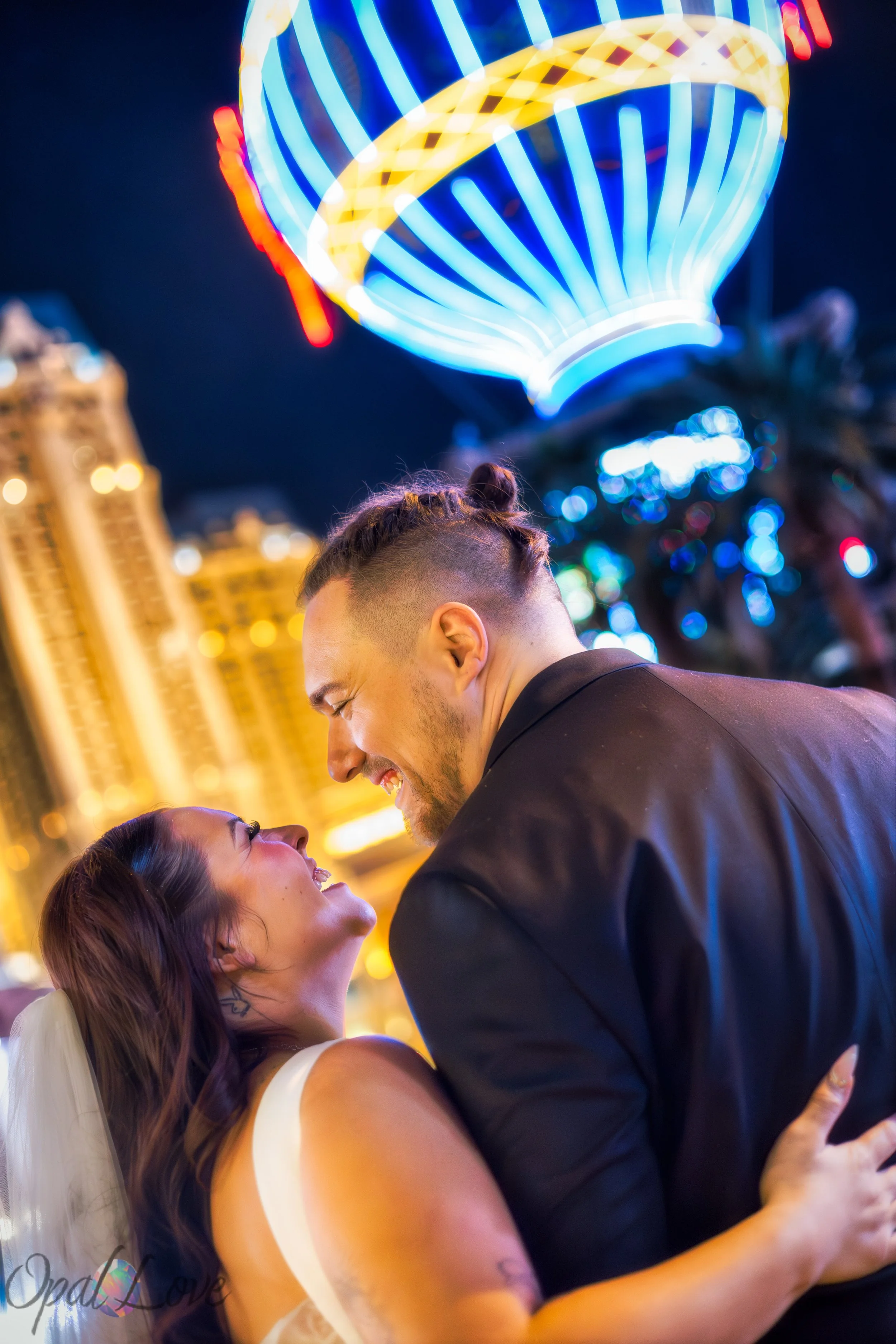 Close up of couple smiling together during their Paris Las Vegas anniversary photos.