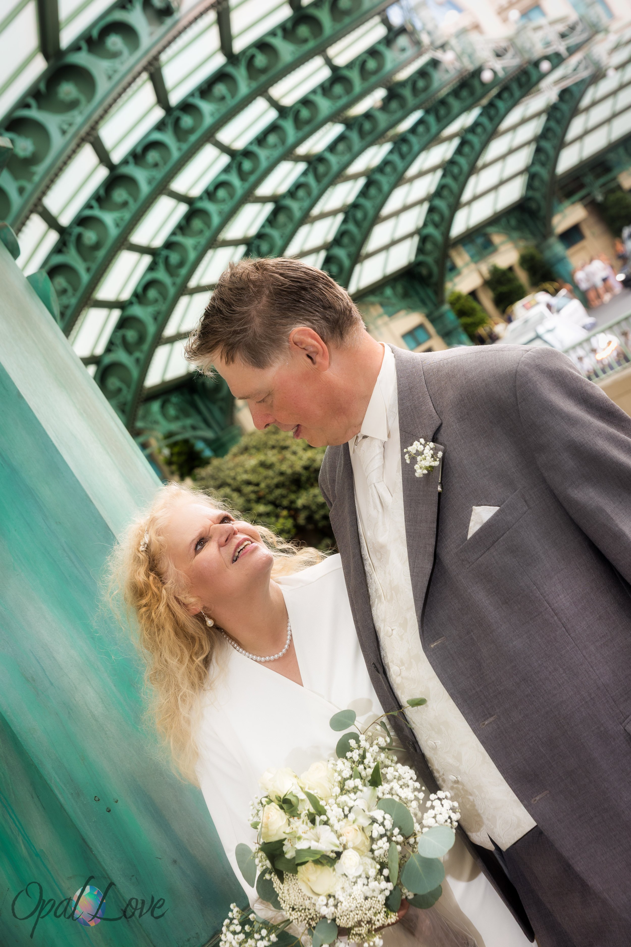 Couple standing under green canopy at Paris Las Vegas entrance