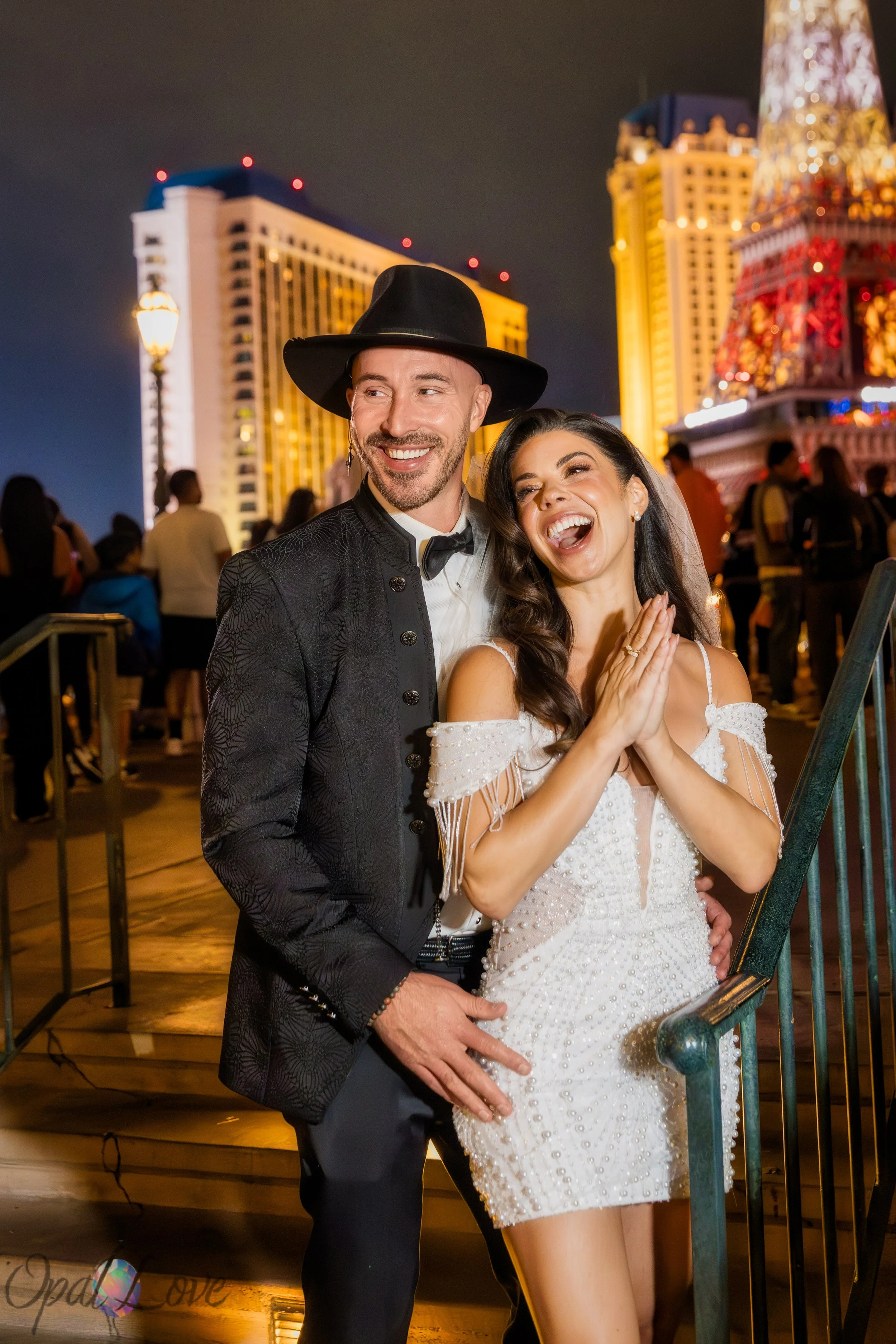 Couple smiling at each other in front of Bellagio fountain during Las Vegas wedding photos