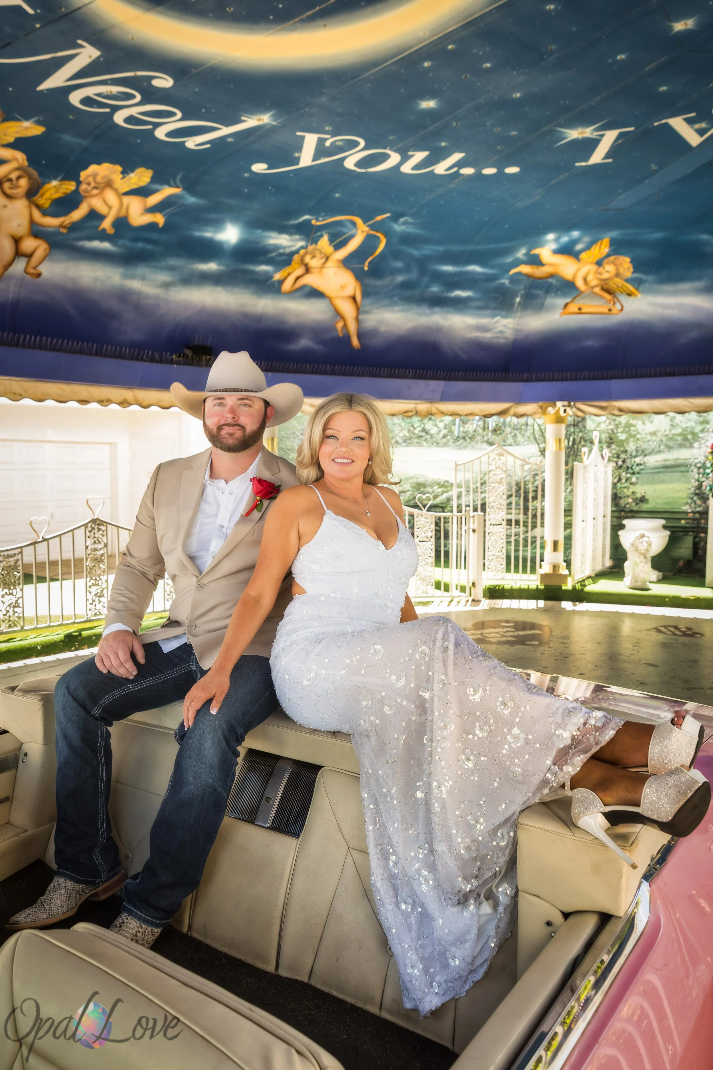 Newlywed couple sitting inside the pink Cadillac at Little White Wedding Chapel in Las Vegas