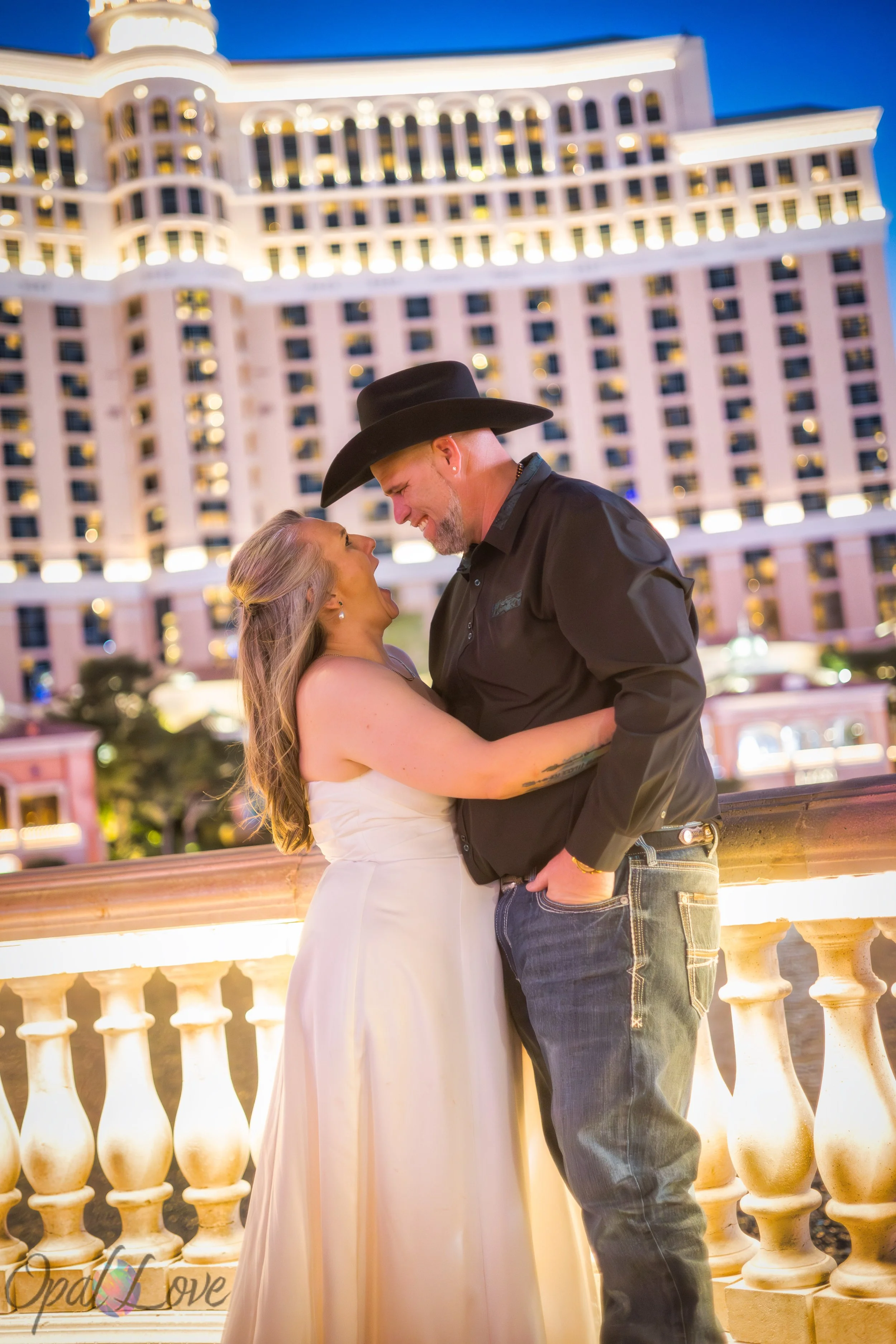Couple sitting together with Bellagio architecture and Las Vegas Strip lights