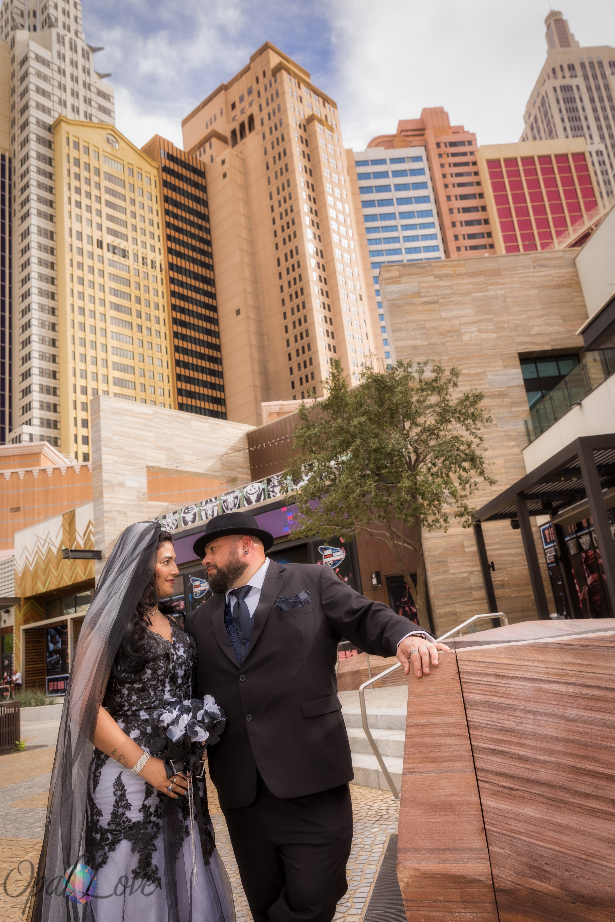 Couple posing near the tall New York New York buildings on the Las Vegas Strip.