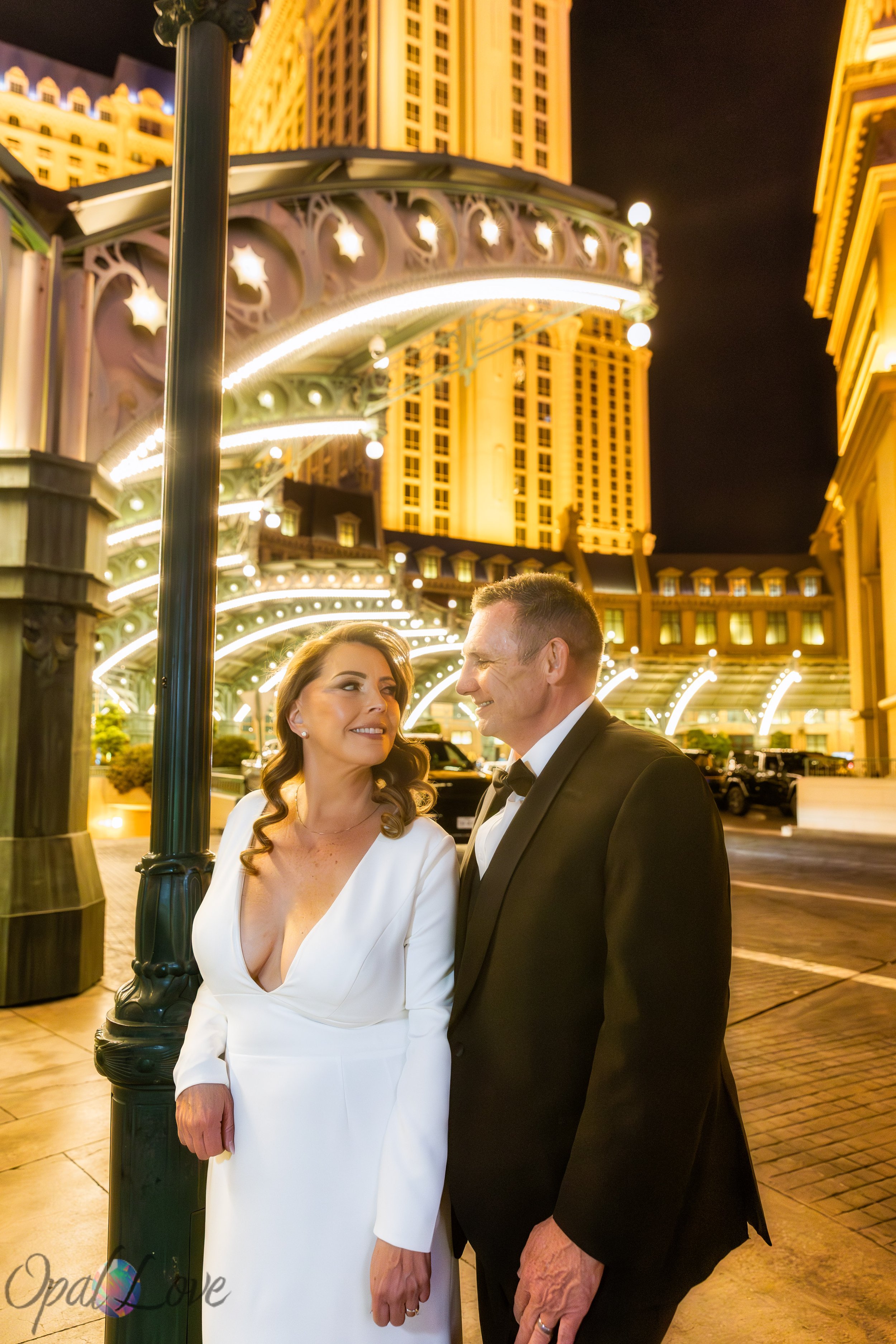 Couple smiling together on Las Vegas Strip near Paris Las Vegas at night