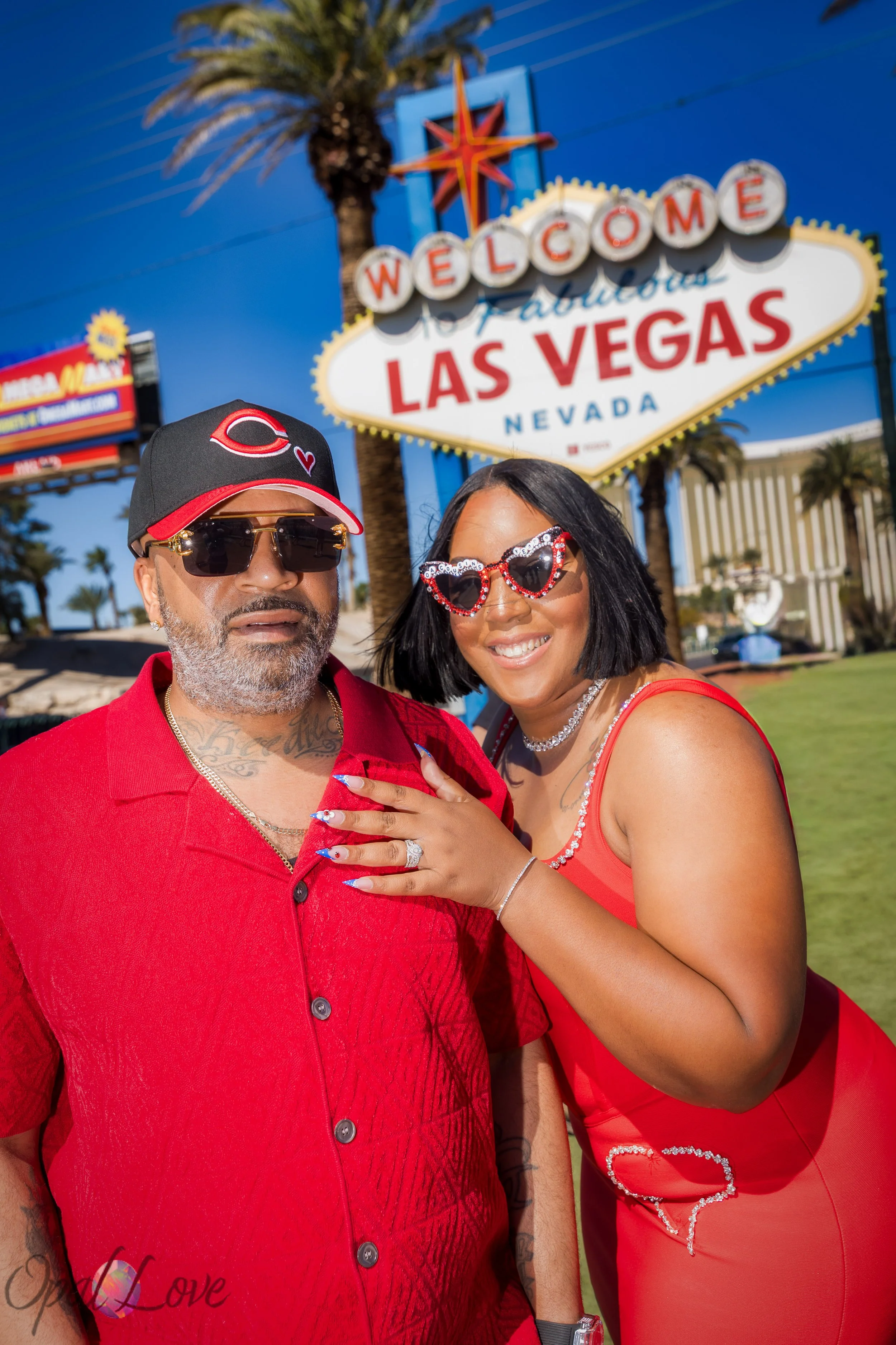 Couple celebrating their anniversary at the Welcome to Fabulous Las Vegas sign where they originally got married eight years ago.