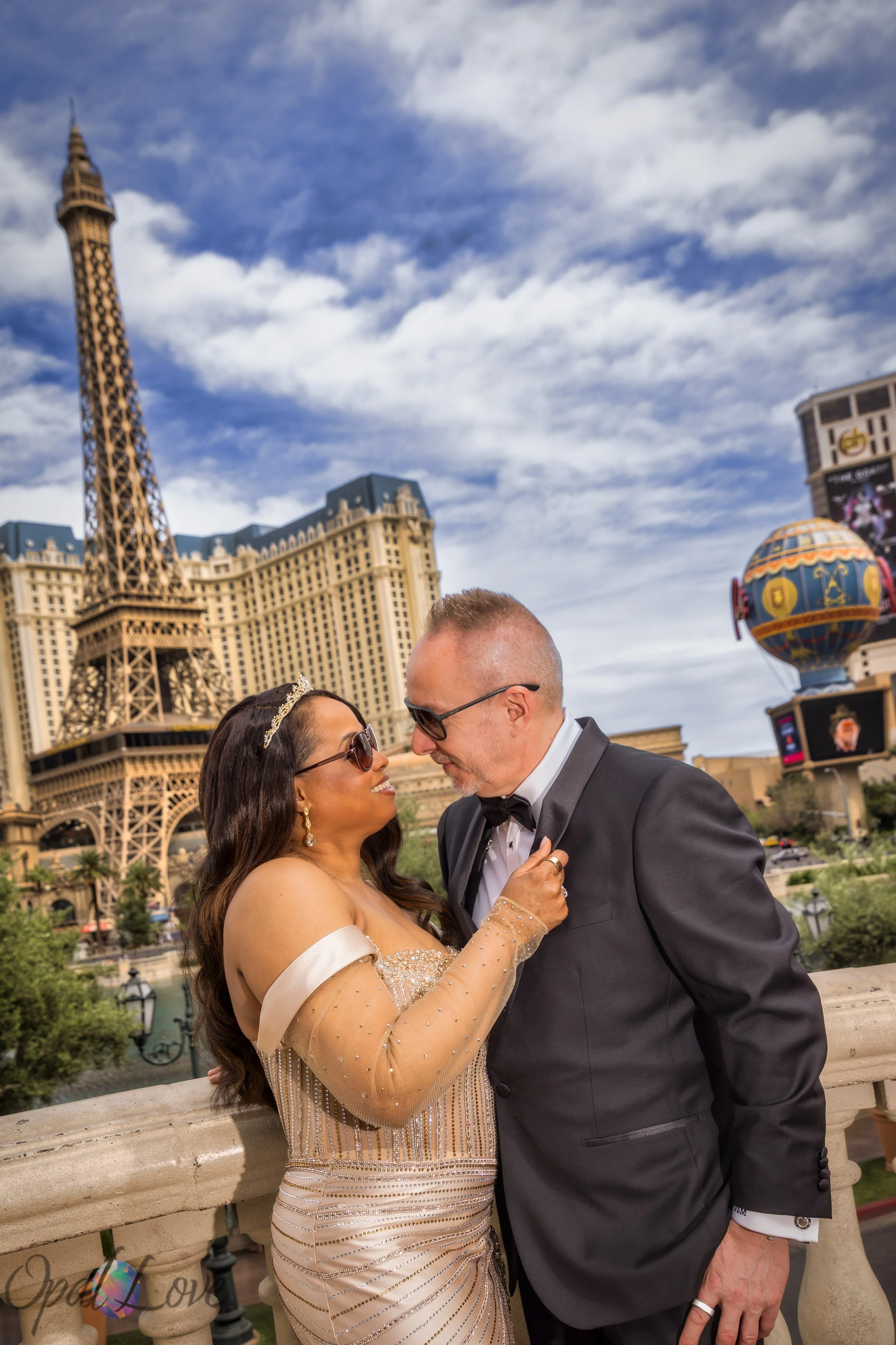 Couple posing at Bellagio fountains with Paris Las Vegas Eiffel Tower in the background during Las Vegas elopement photo session