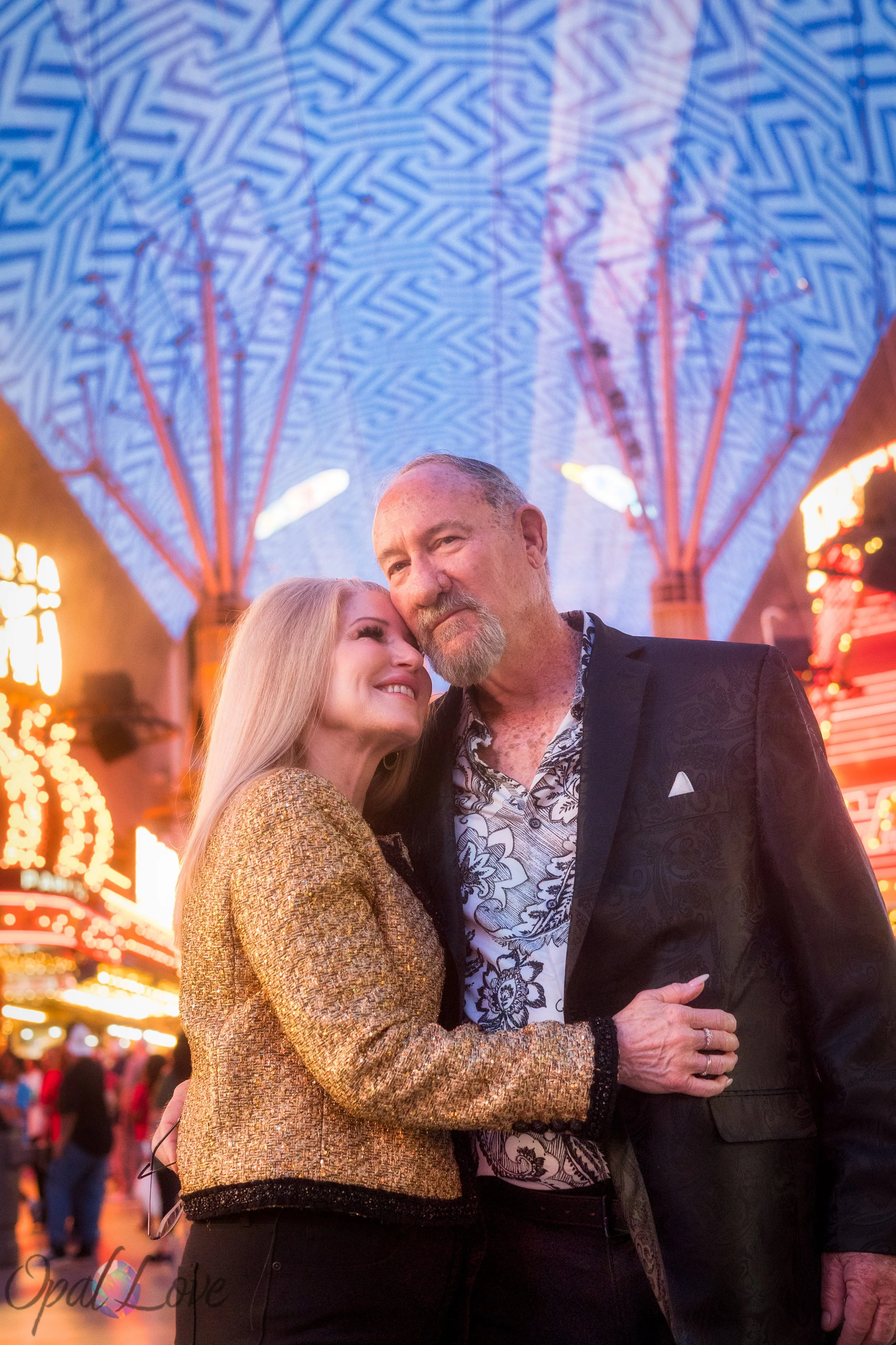 Couple embracing underneath the Fremont street canopy on their anniversary photo tour