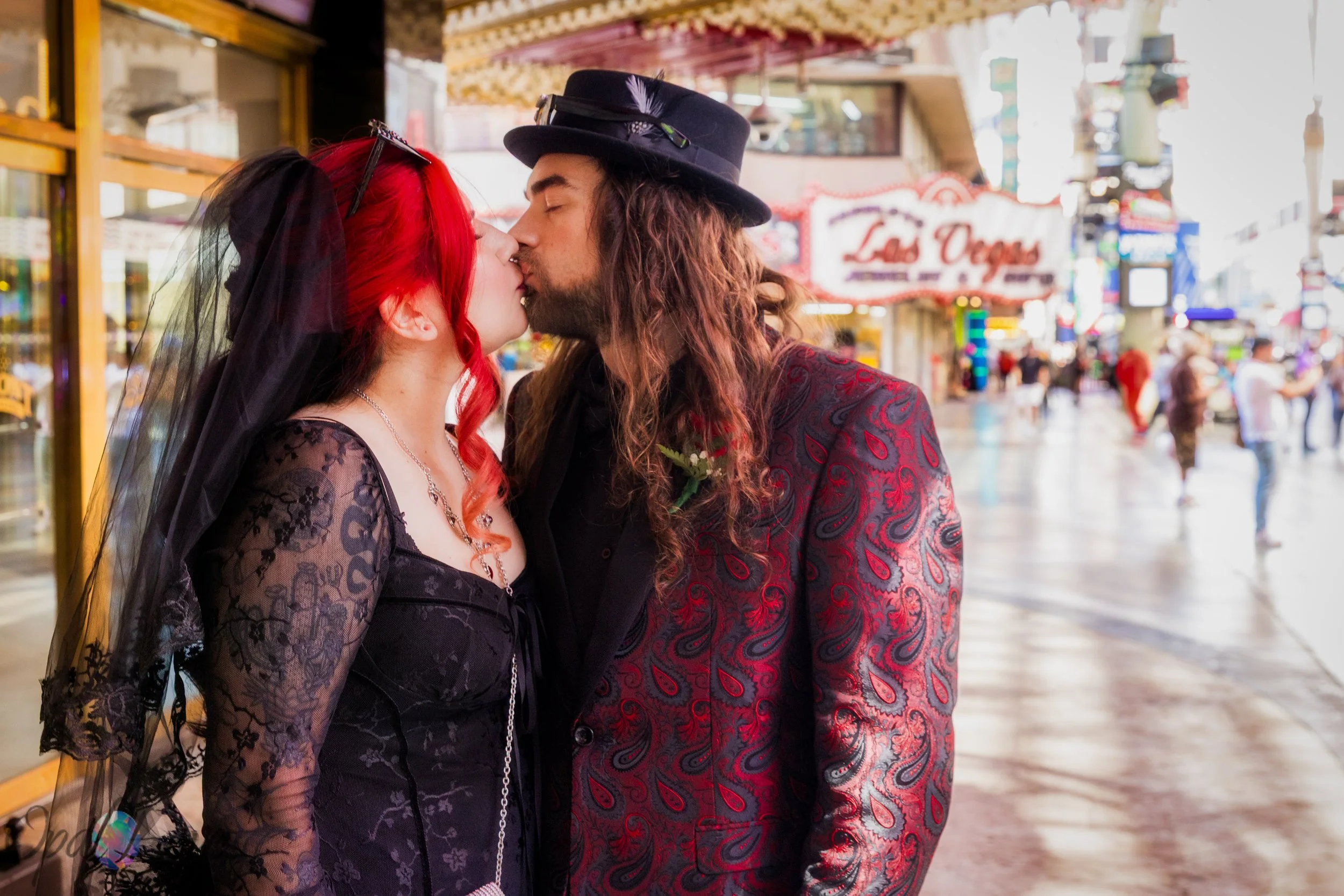 Newlywed couple kissing inside Fremont Street Experience in Downtown Las Vegas
