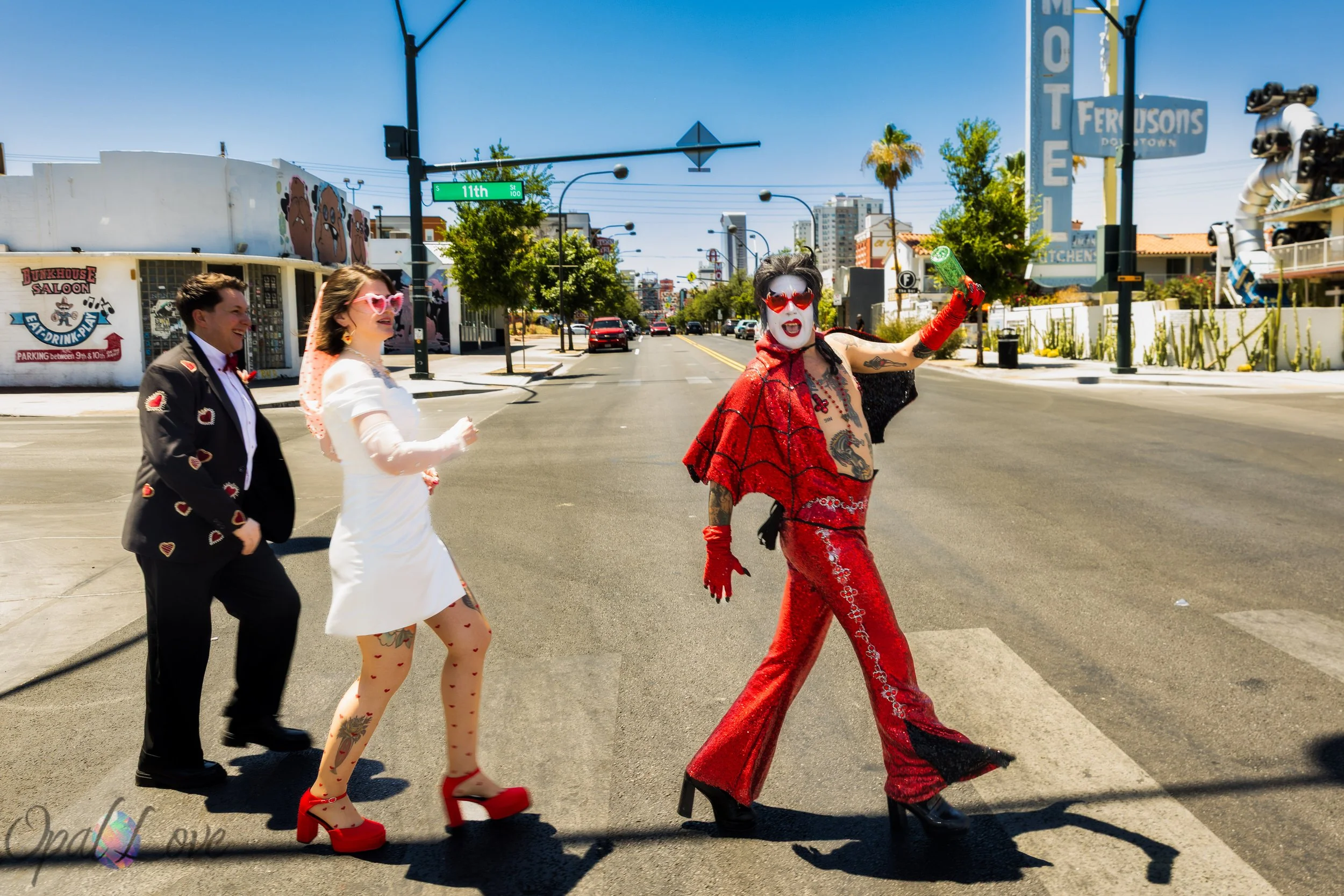 Rachel and Tom walk through Downtown Las Vegas with Hellvis following their wedding ceremony at A Sure Thing Wedding Chapel.