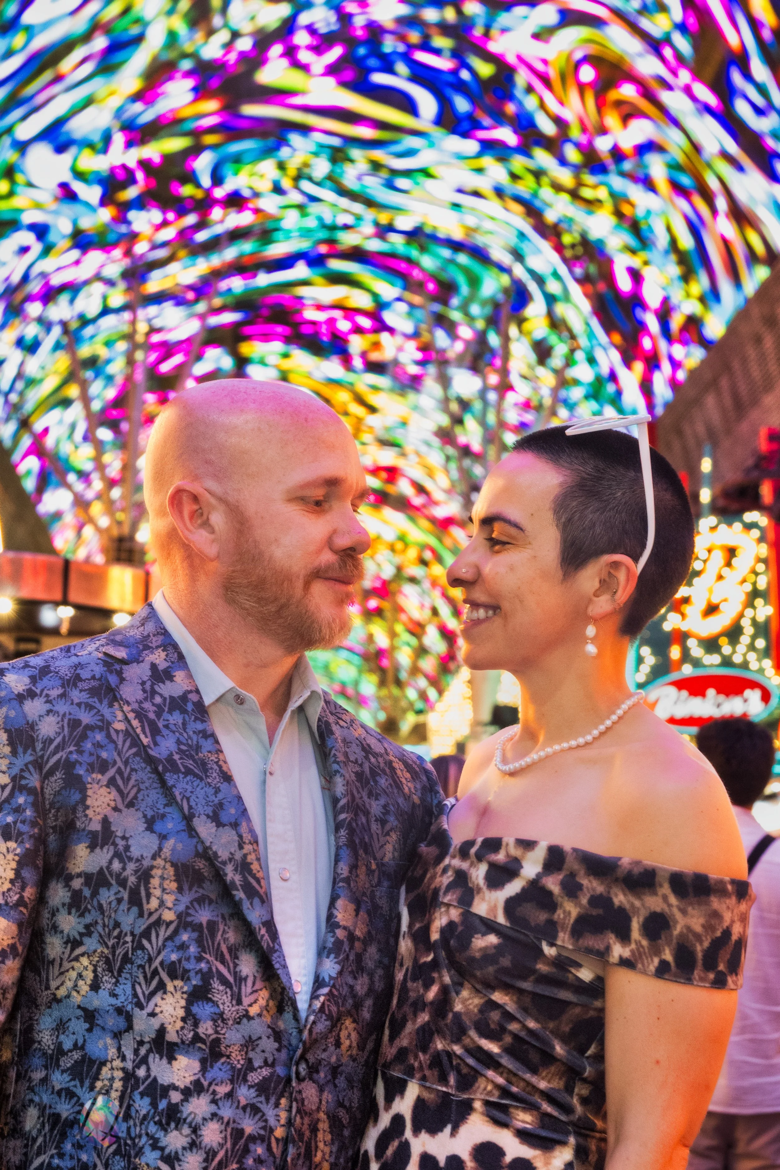 Close portrait of Maddie and Ashley together beneath the colorful Fremont Street Experience canopy in Downtown Las Vegas.