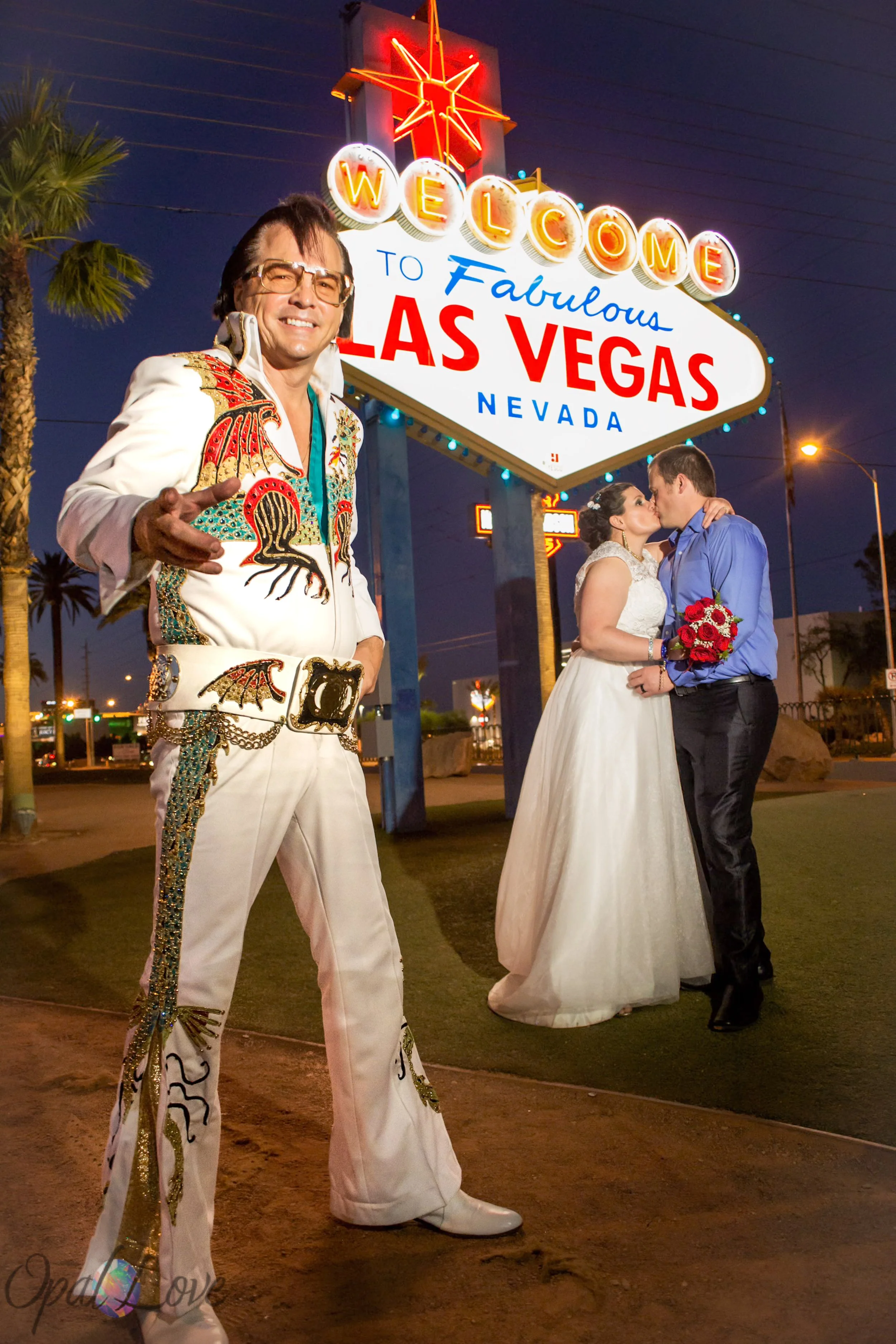 Las Vegas wedding couple with Elvis at the Welcome to Fabulous Las Vegas sign