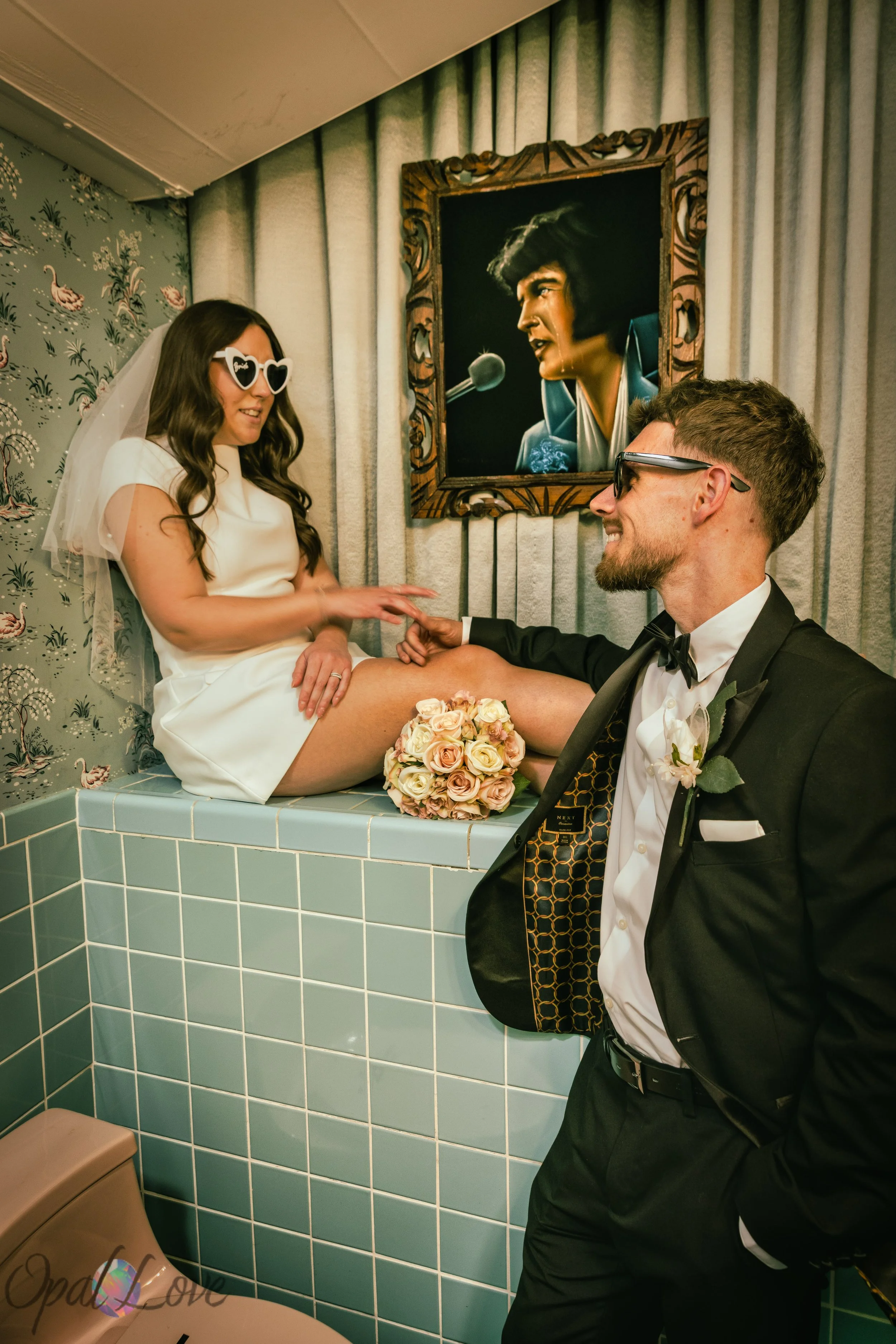 Couple posing inside the famous bathroom at A Sure Thing Wedding Chapel during Las Vegas vow renewal