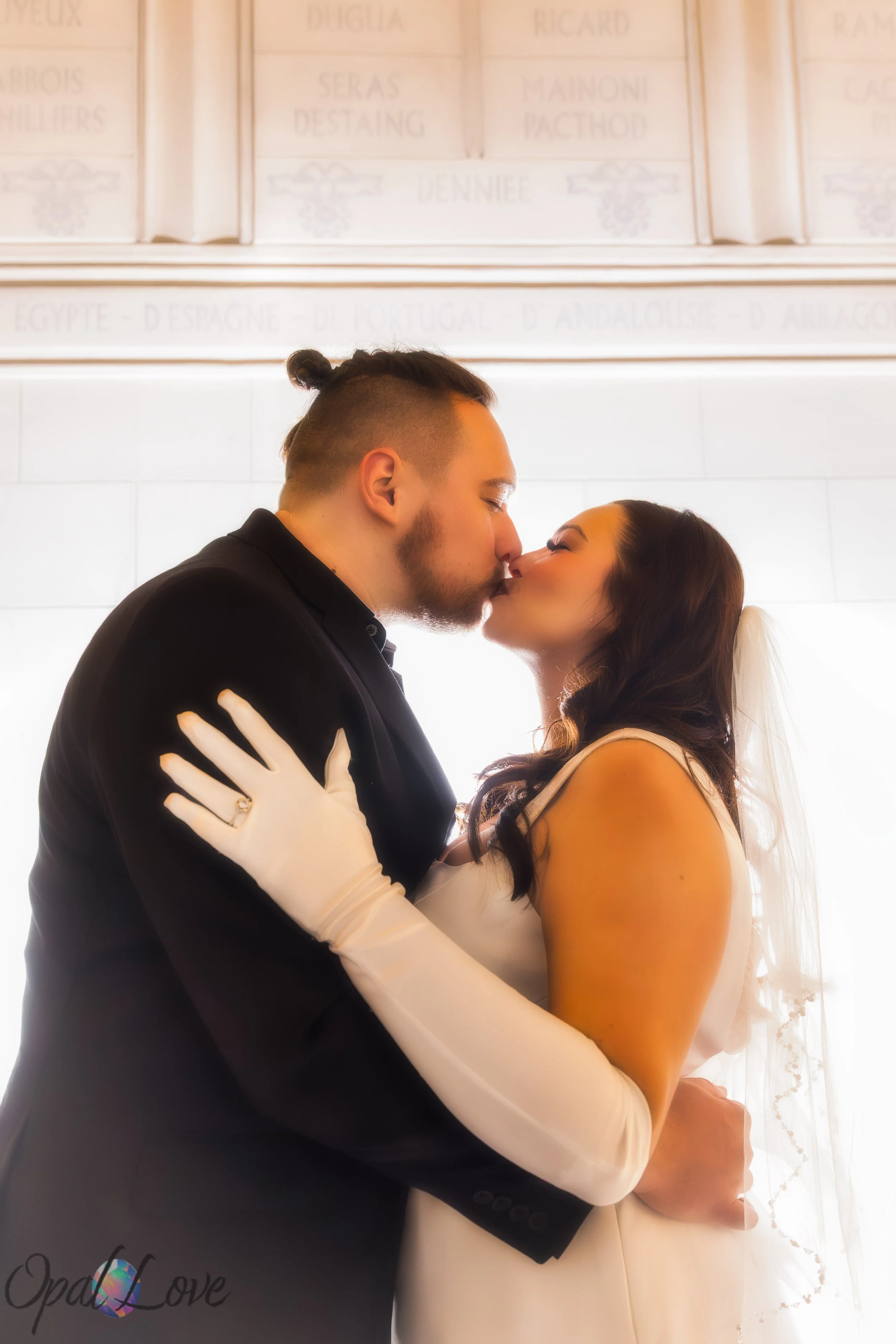 Anniversary couple hugging on the Strip with Paris Las Vegas lights in the background.
