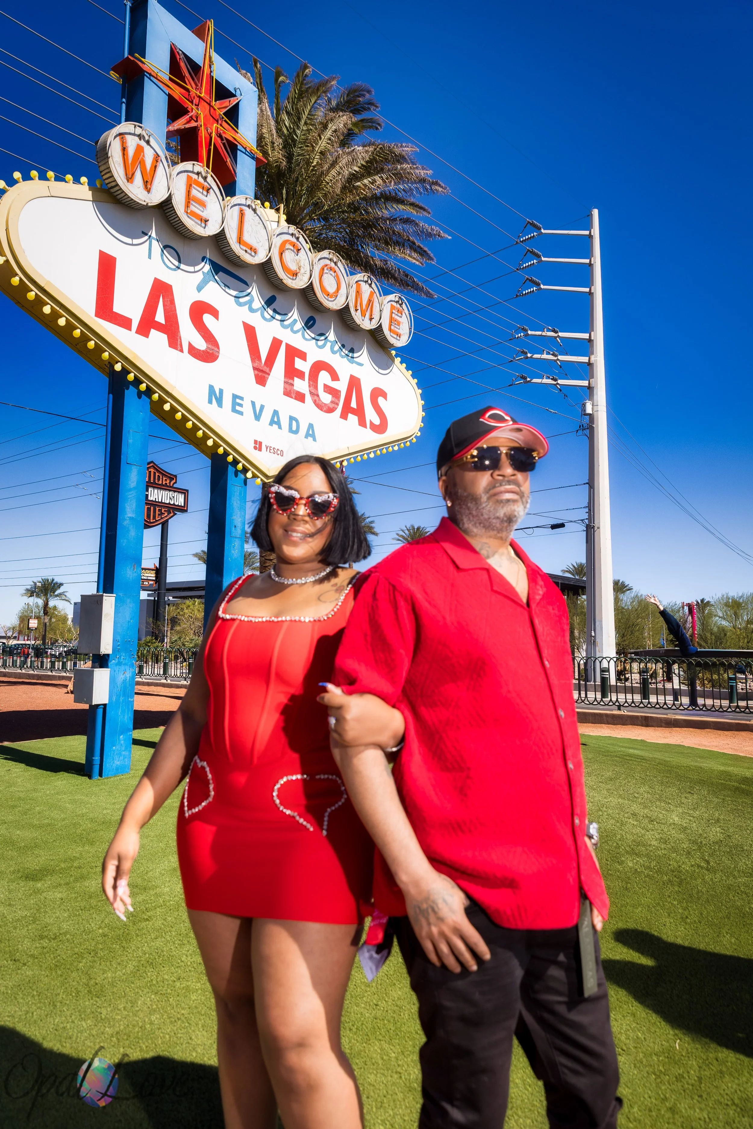 Married couple walking together beneath the Welcome to Fabulous Las Vegas sign during their anniversary photos in Las Vegas.