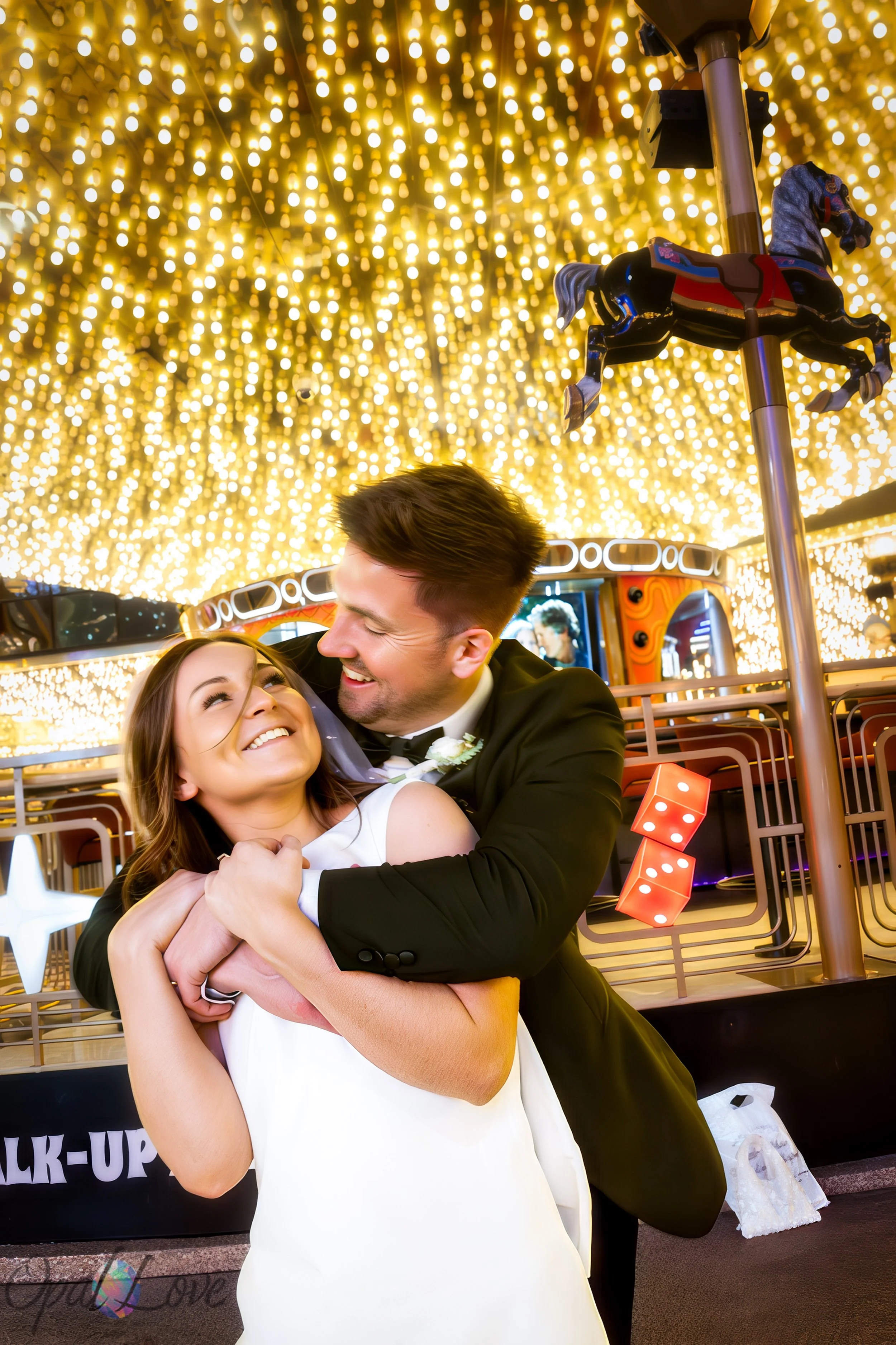 Couple hugging in front of Carousel Bar lights at Plaza Hotel Fremont Street