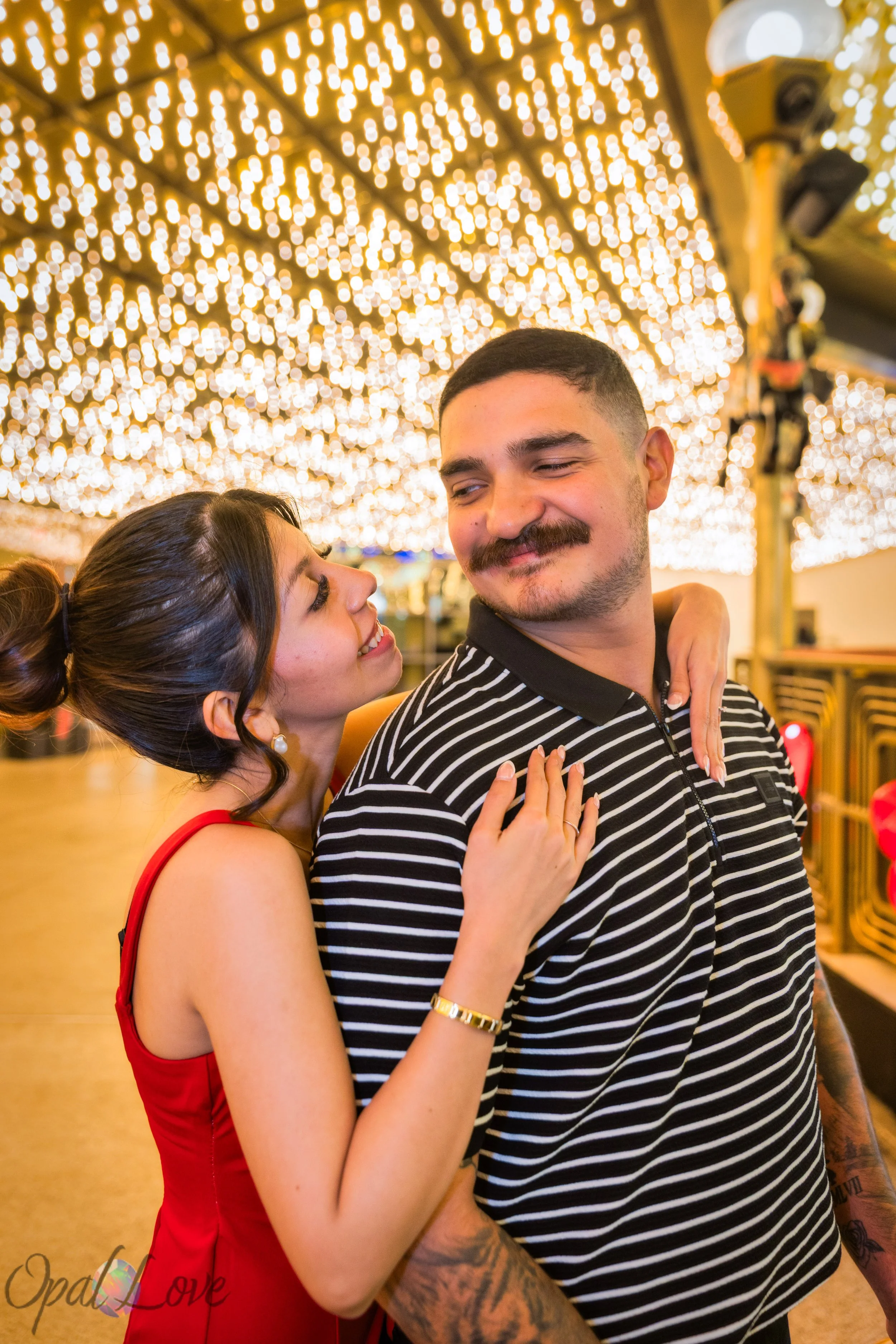 Romantic portrait of couple under warm marquee lights in Downtown Las Vegas
