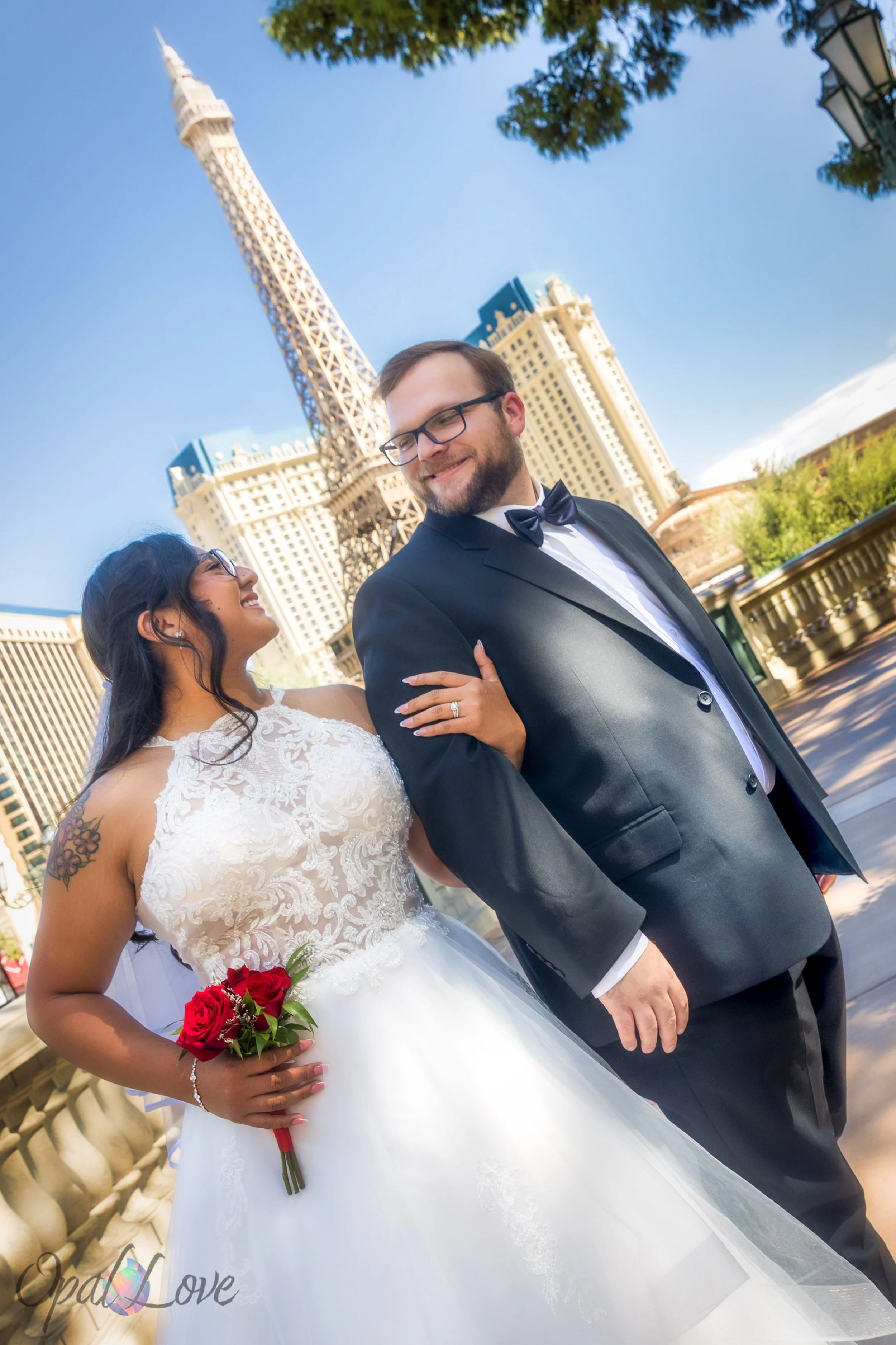 Couple smiling at the Bellagio with Eiffel Tower replica behind them during Las Vegas elopement.