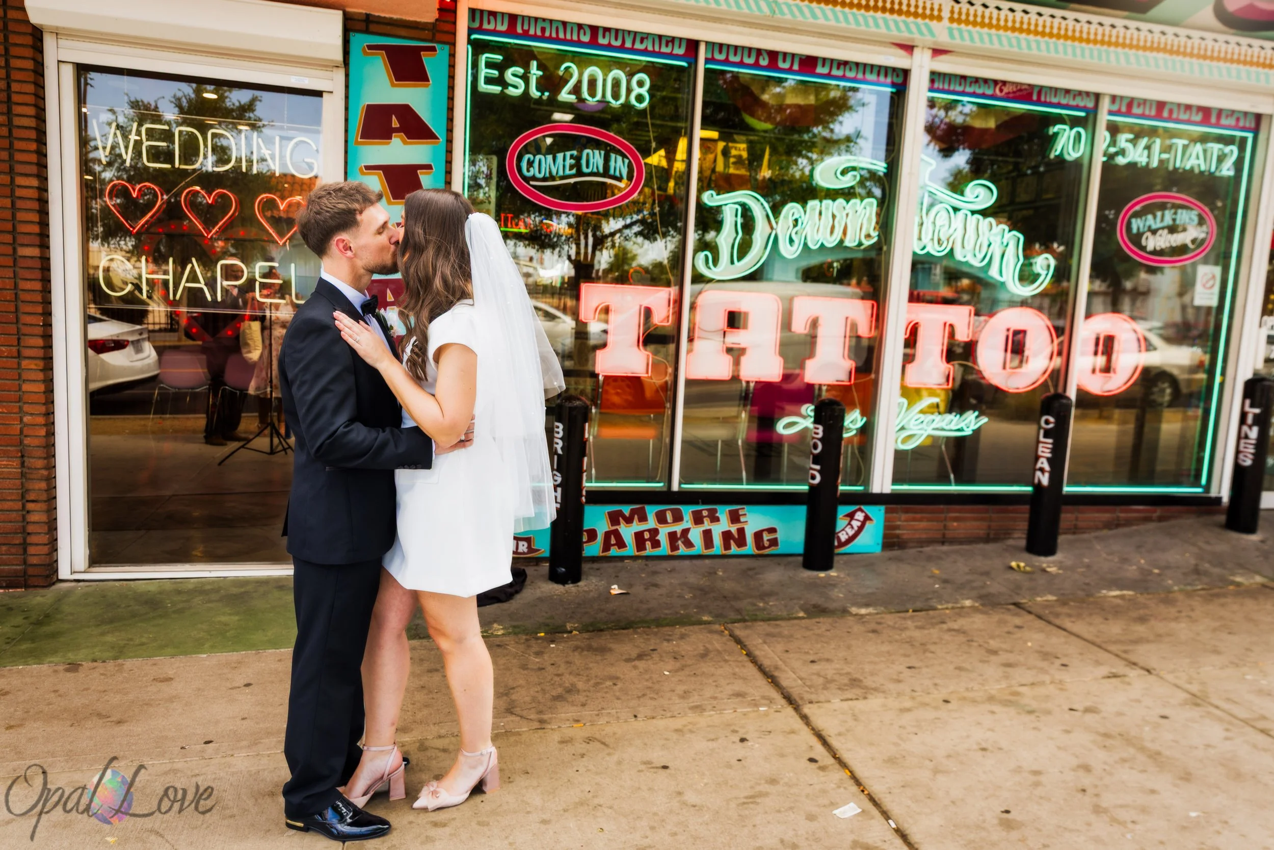 Couple standing outside vintage tattoo shop near A Sure Thing Wedding Chapel in Downtown Las Vegas