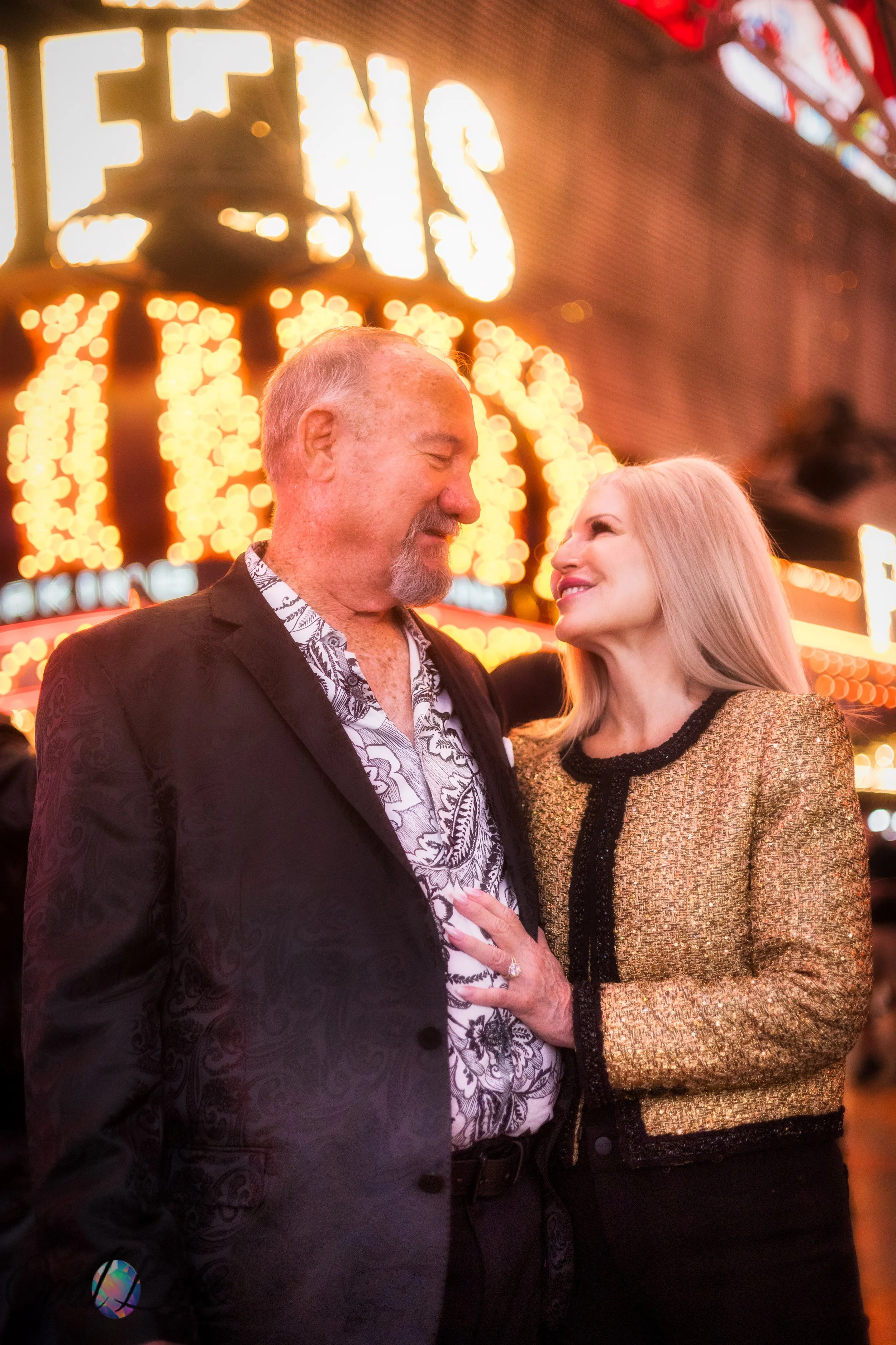Couple standing near the bright 4 Queens lights during their downtown Las Vegas shoot.