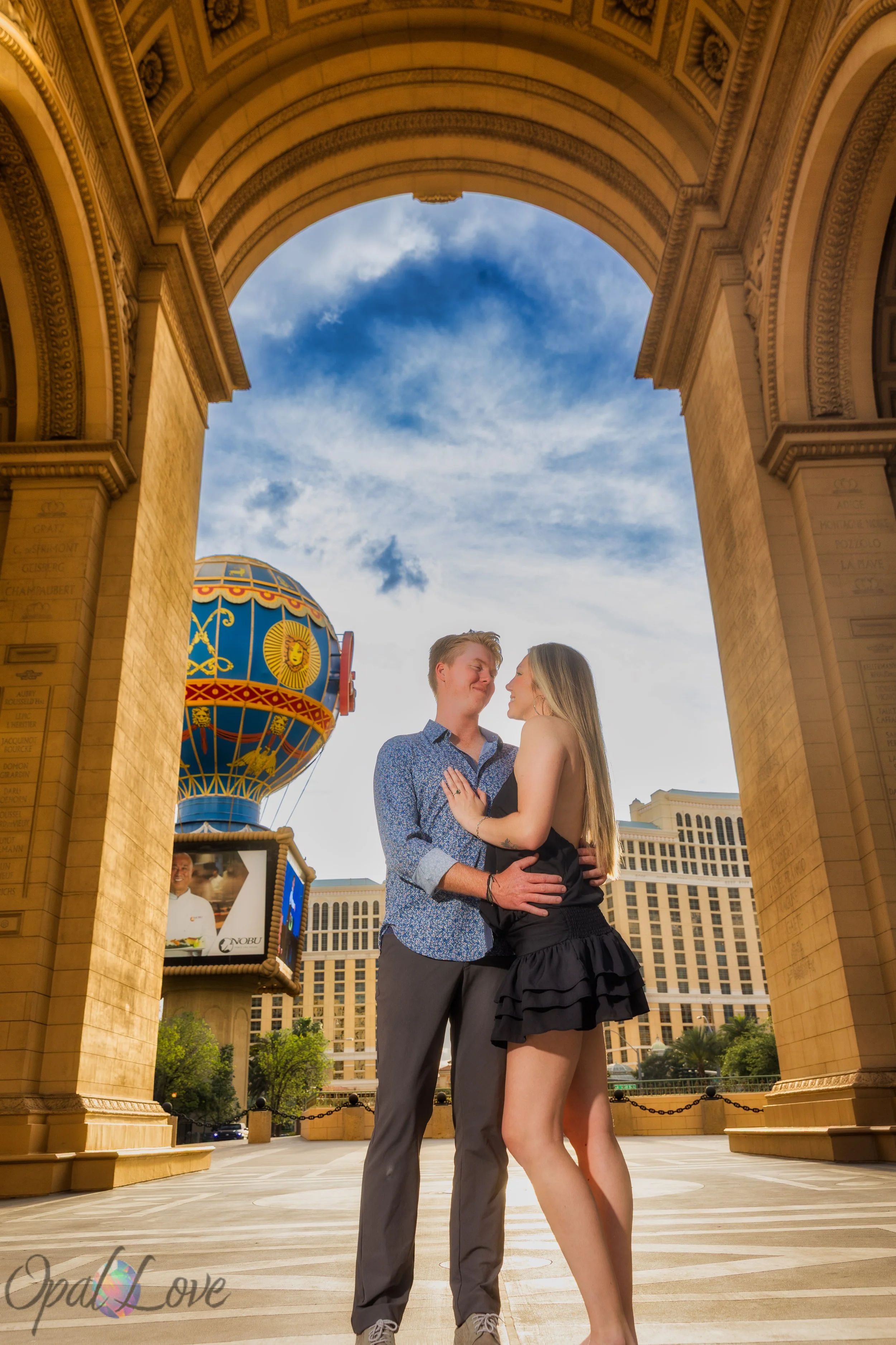 Couple posing near Paris Las Vegas balloon on the Las Vegas Strip