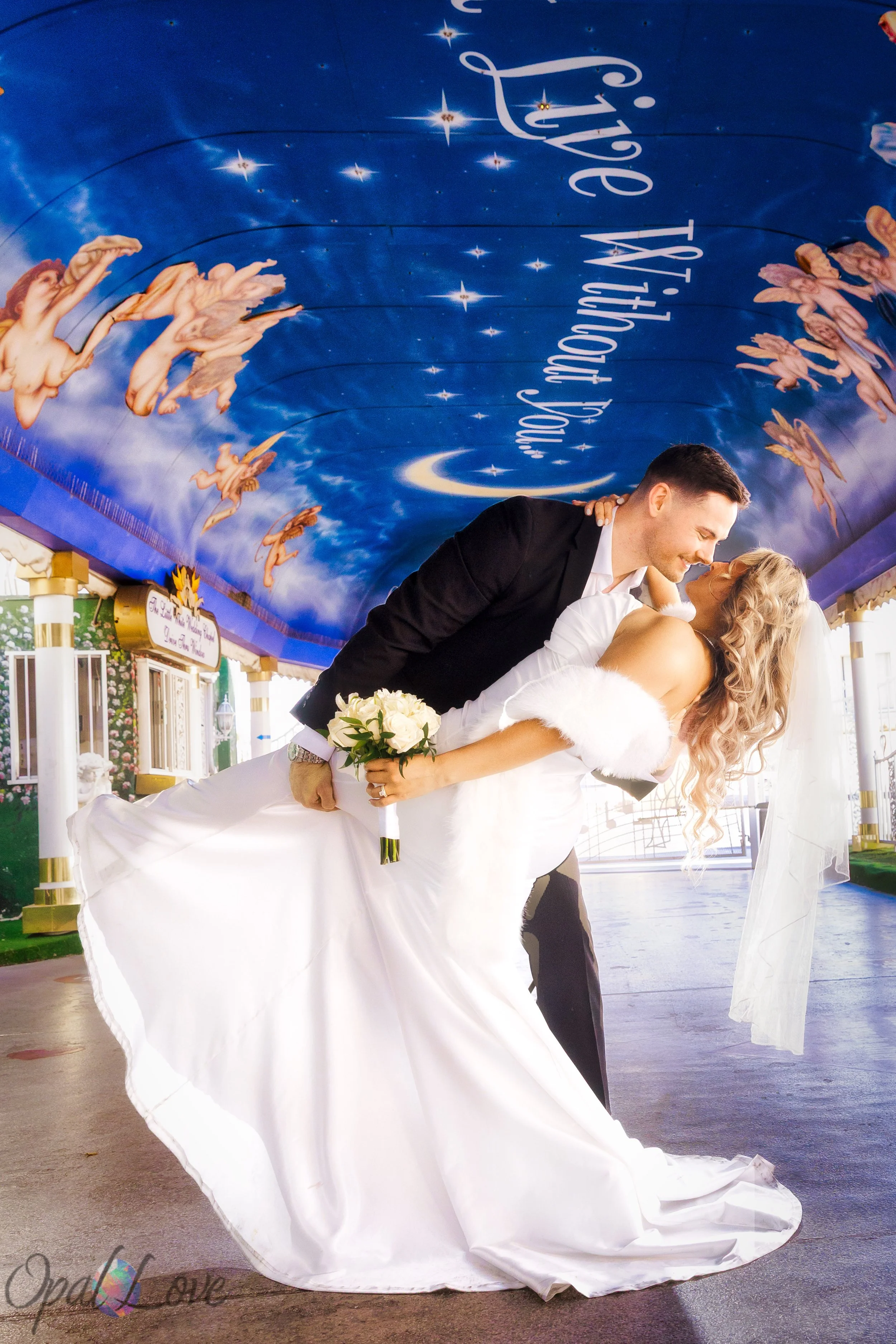 Groom dipping bride for a playful kiss during their Las Vegas elopement photo session.