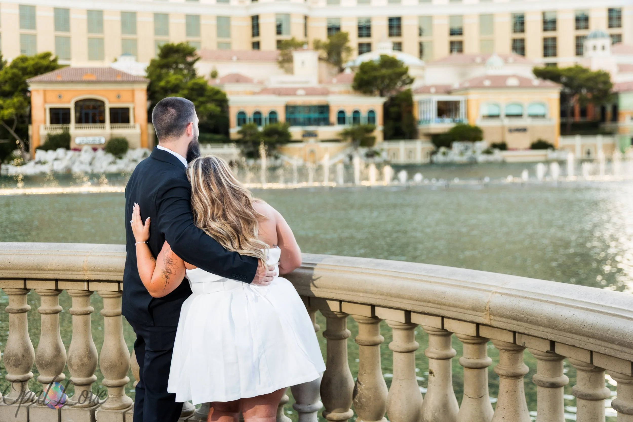 Husband and wife watching the Bellagio Fountains together during their 10 year anniversary photography session in Las Vegas.