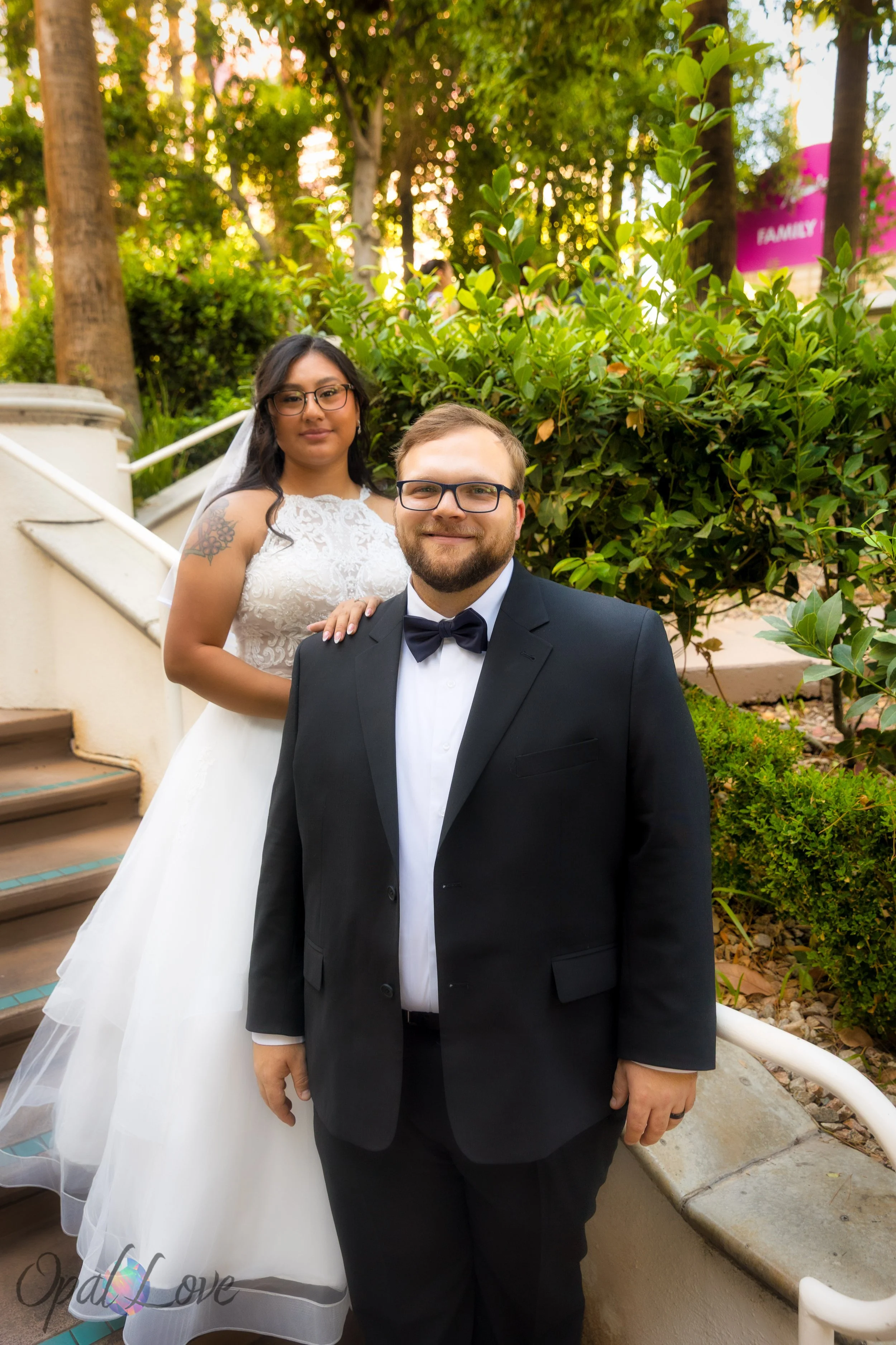 Couple posing on garden staircase surrounded by greenery at Flamingo Las Vegas.